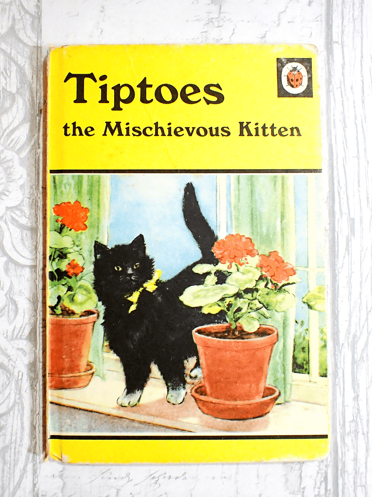 Vintage Ladybird children's book Tiptoes the Mischievous Kitten yellow cover showing black kitten.