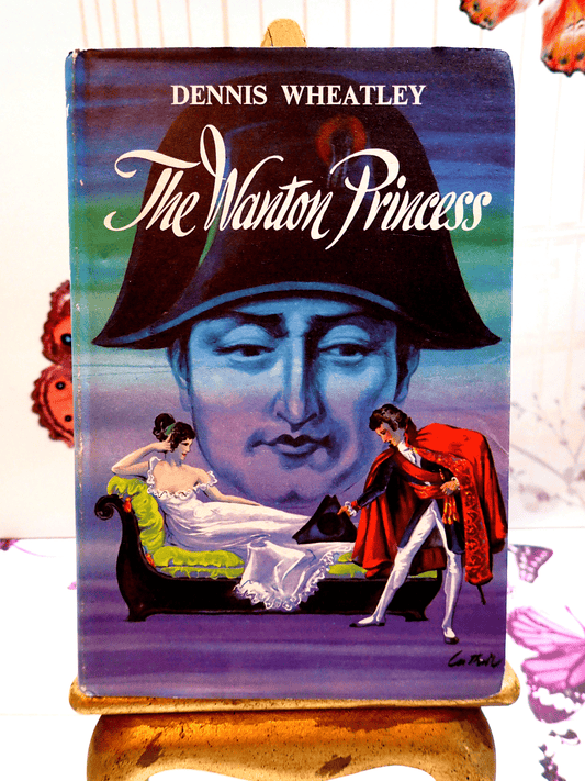 Front cover of The Wanton Princess Dennis Wheatley first edition thus, showing a looming image of Napoleon and the hero Roger Brook bowing to a lady on a chaise longue. 