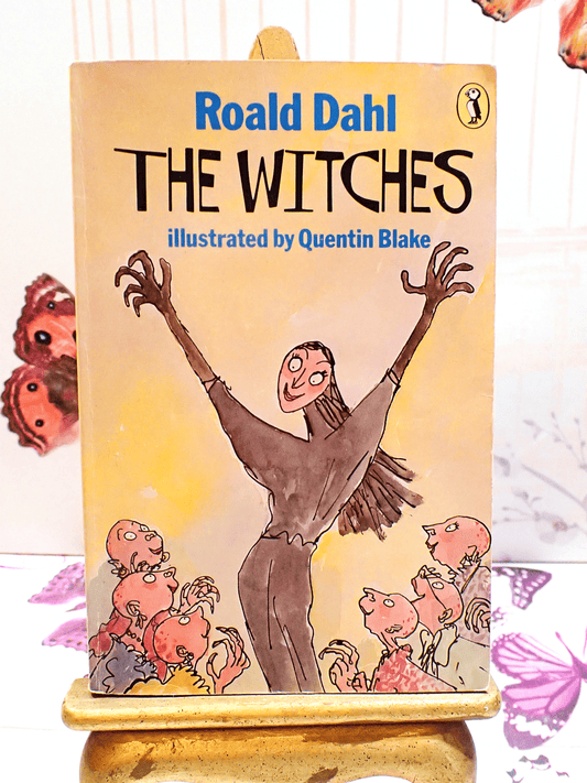 Cover of Vintage Puffin Paperback Roald Dahl 'The Witches' showing a witch with arms raised and titles in blue and black with puffin logo. 