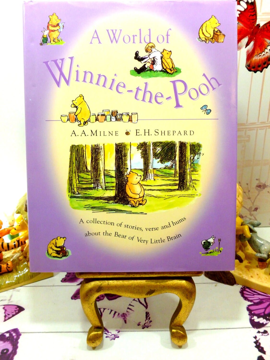 Front cover of A World of Winnie the Pooh Vintage Hardback Childrens Book illustrated with images of Christopher Robin and Pooh against a lilac ground.