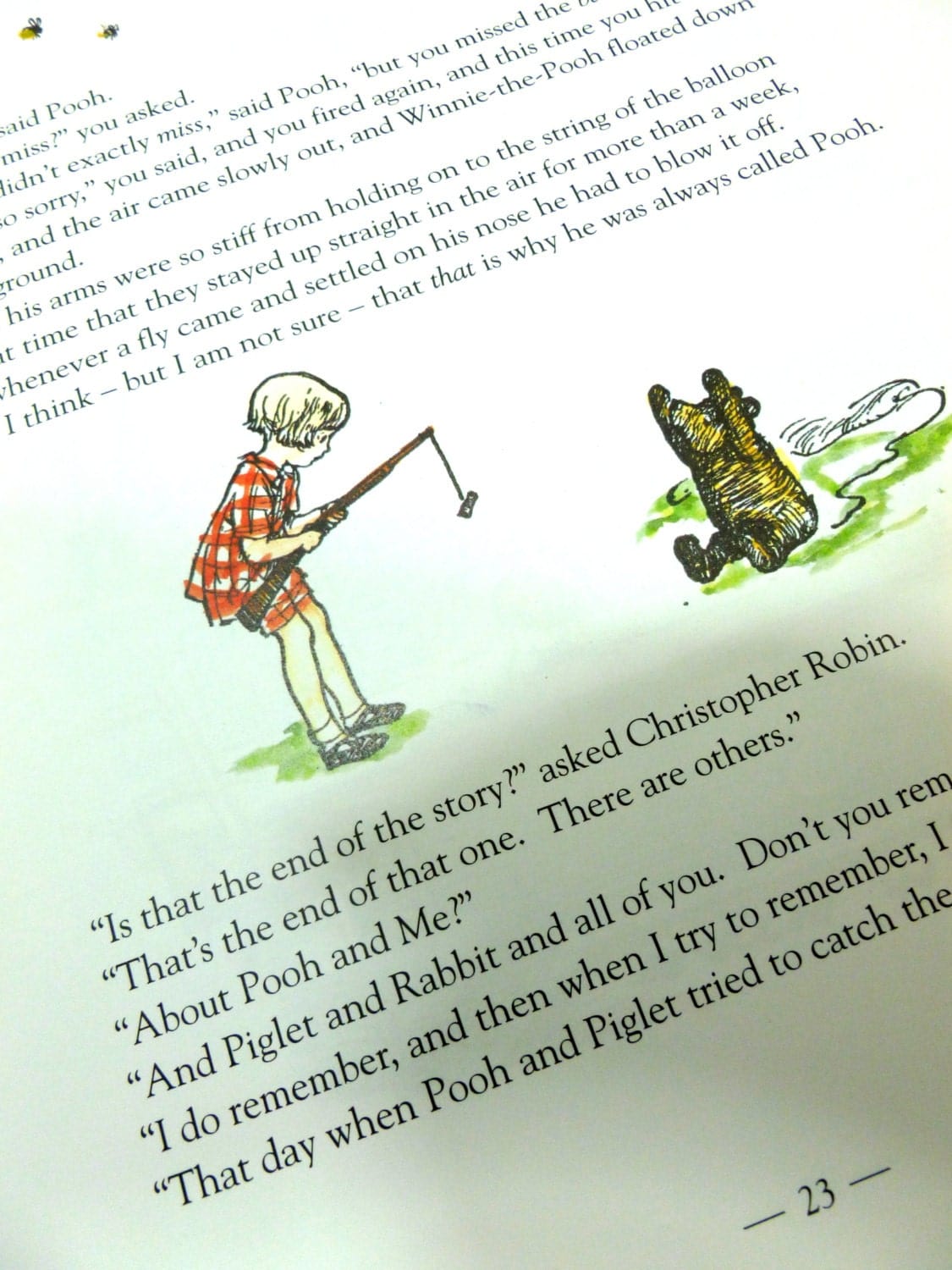 Christopher Robin holding a fishing rod with Pooh bear with his arms up in the air colour illustration.