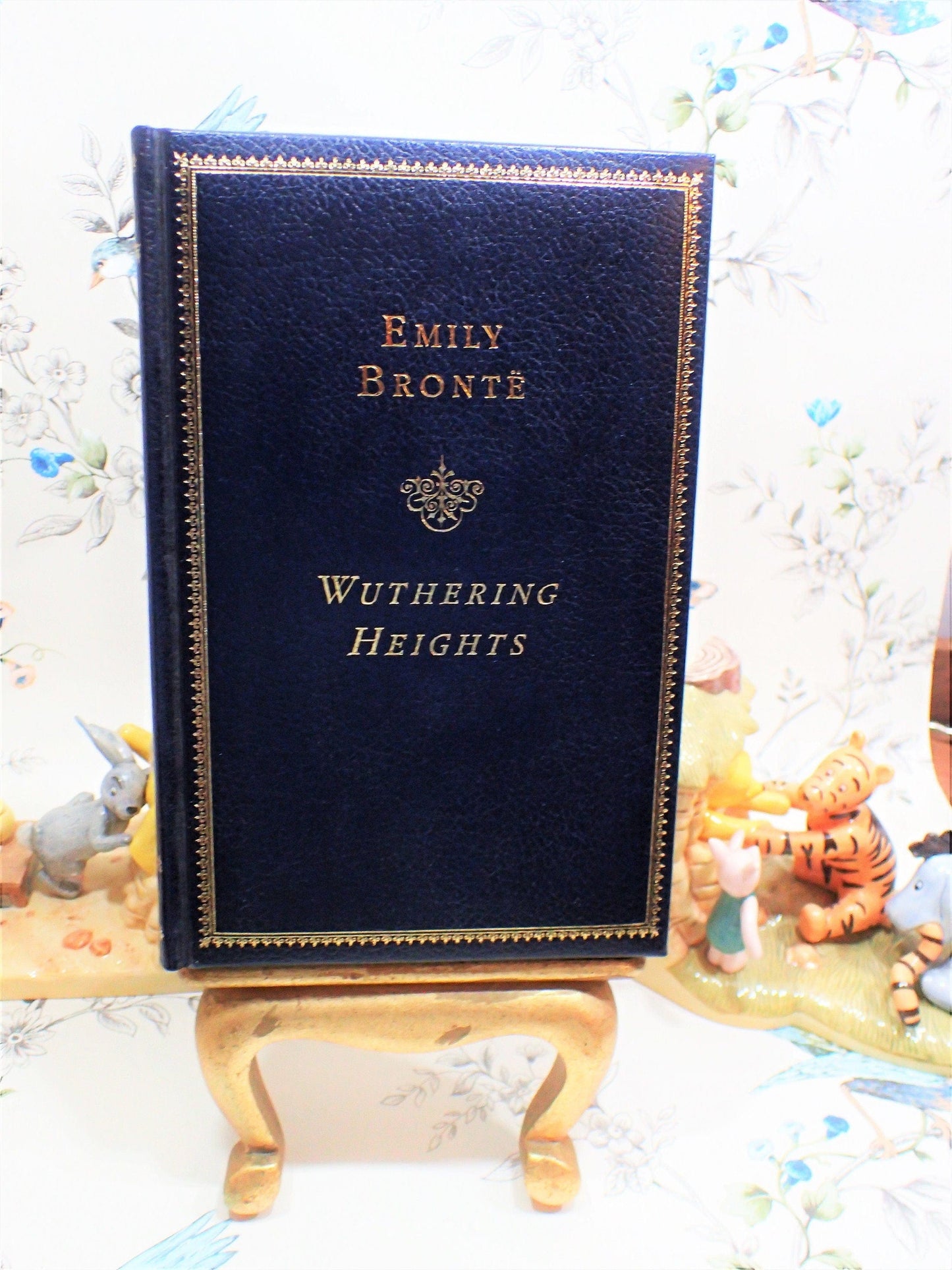 Front cover of Wuthering Heights by Emily Bronte Quality Vintage Book Marble endpapers Gilt Edge, titles and ornamentation to the front cover.
