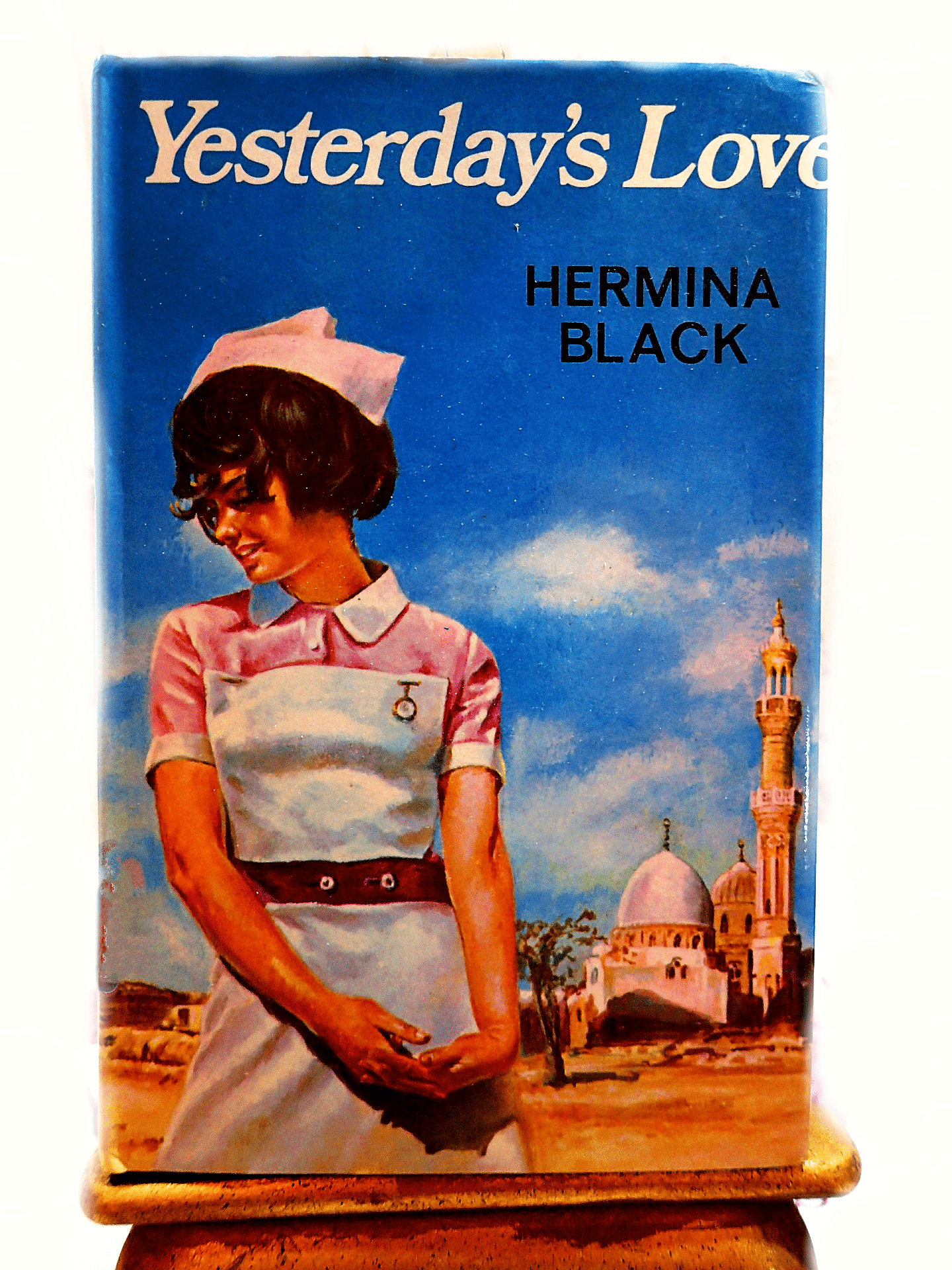 Front cover of Yesterdays Love Hermina Black Romance Book Club Hardback showing a nurse in a vintage uniform.