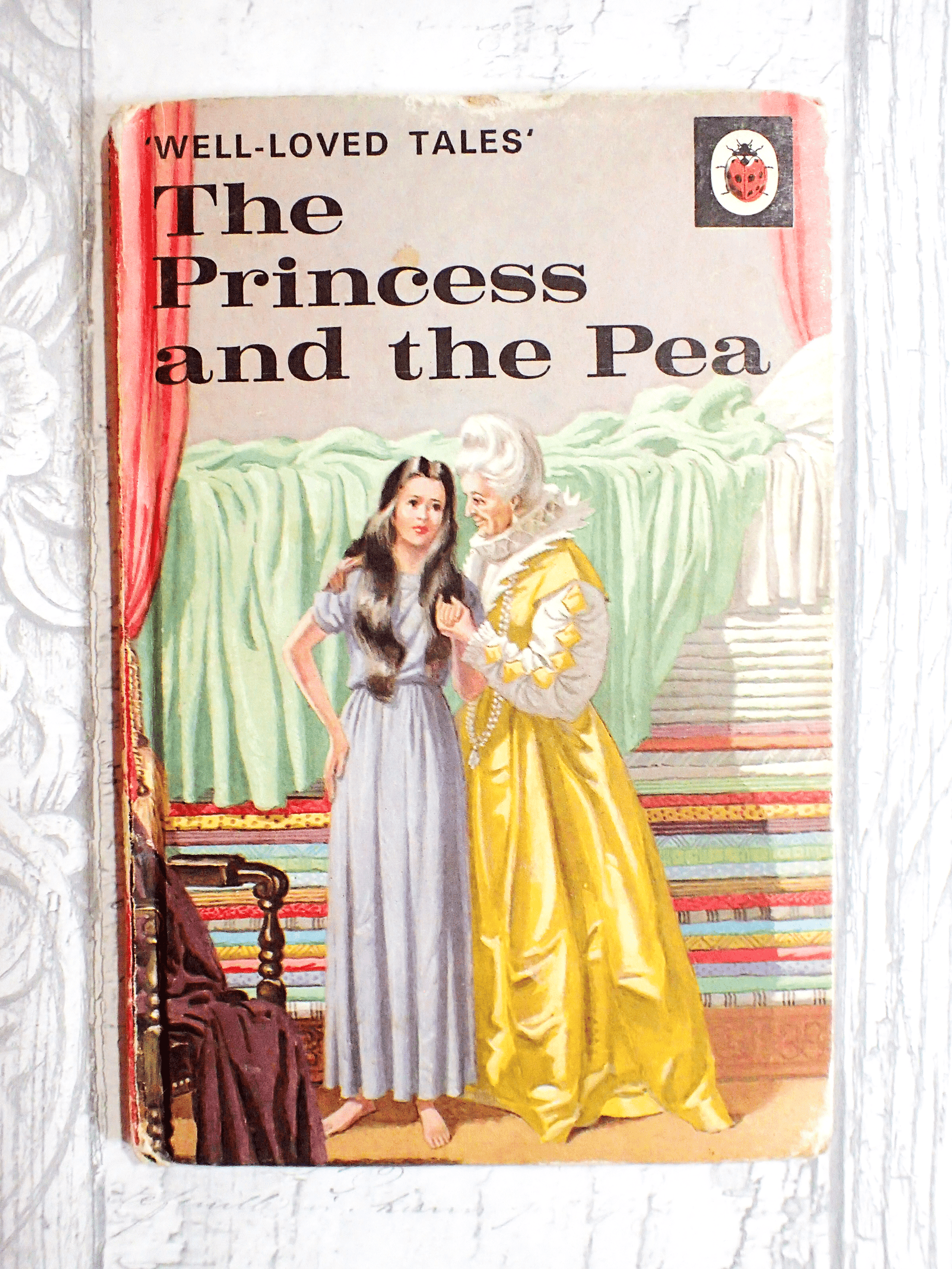 Vintage Ladybird Book The Princess and the Pea against a pale grey background. 