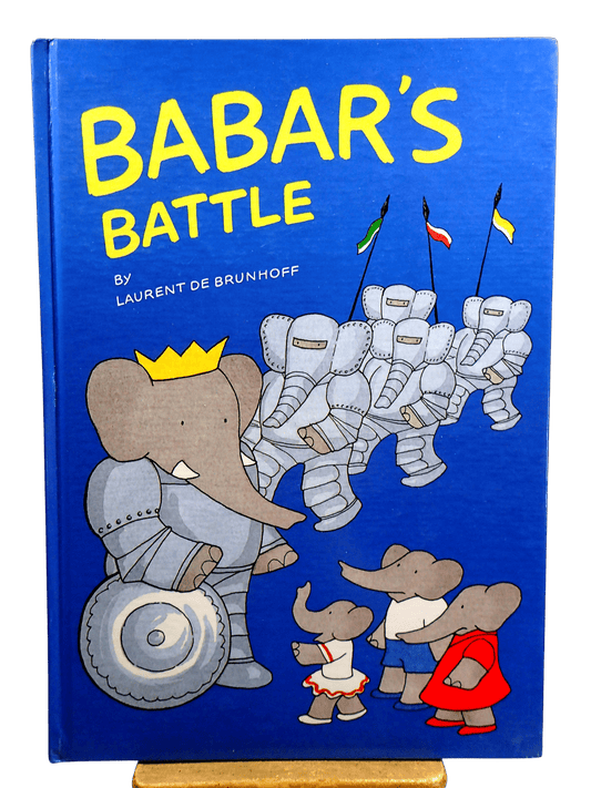 Babar the Elephant in a suit of Armour wearing a crown with other  elephants on Front cover of Babar's Battle First Edition Children's book