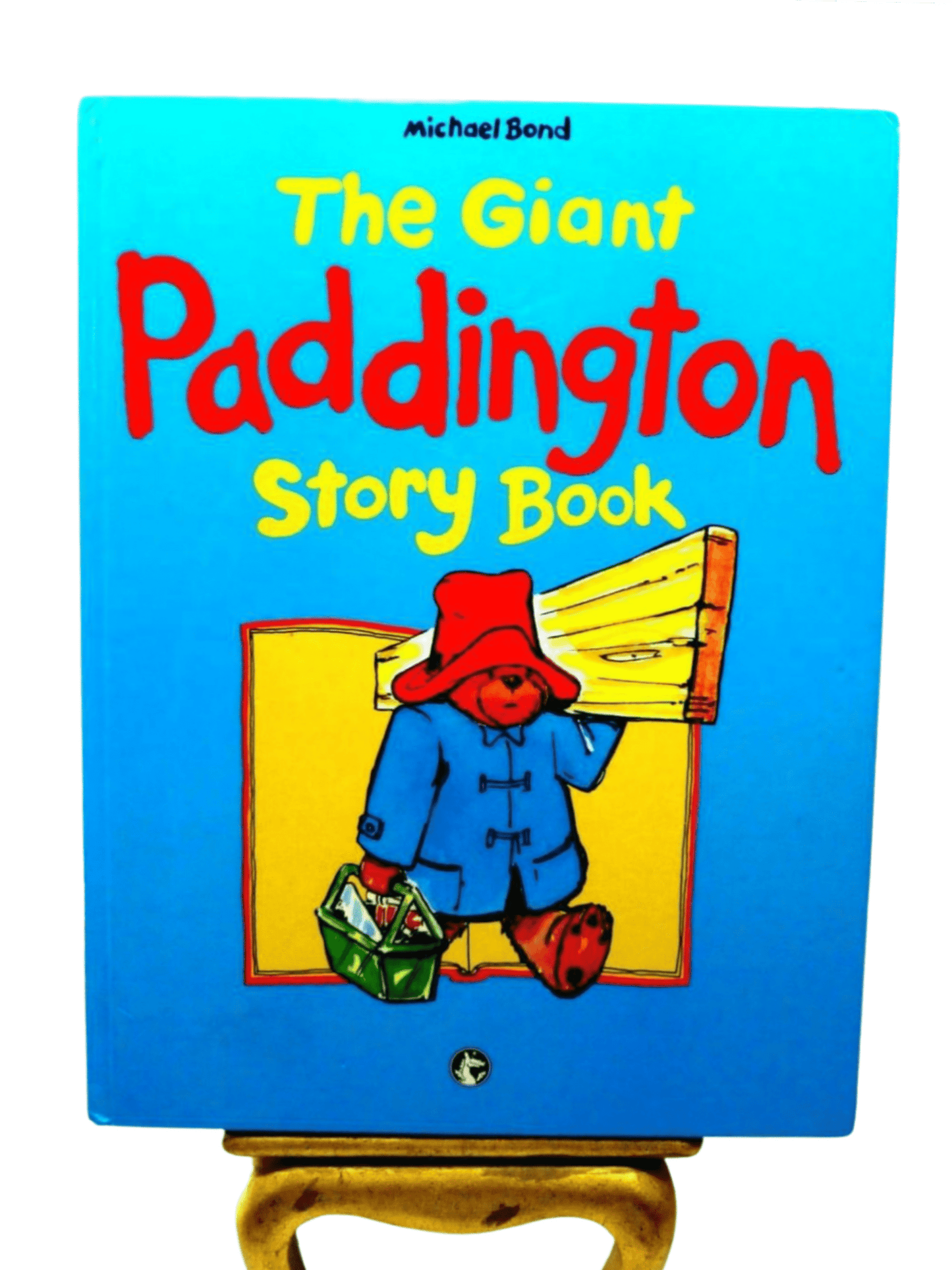 Front Cover of The Giant Paddington Story Book by Michael Bond Paddington Bear First Ed. 1989 showing Paddington Bear carrying some wood and a toolbox. 