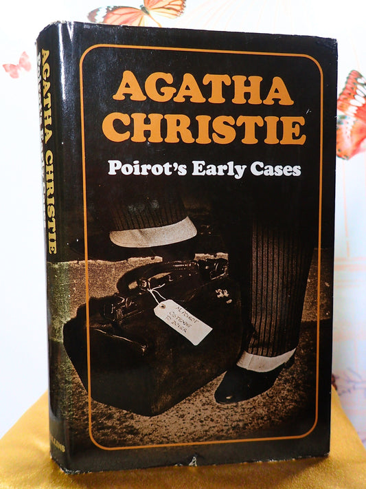 First Edition of Poirot's Early Cases by Agatha Christie showing a portmanteau on the cover. 