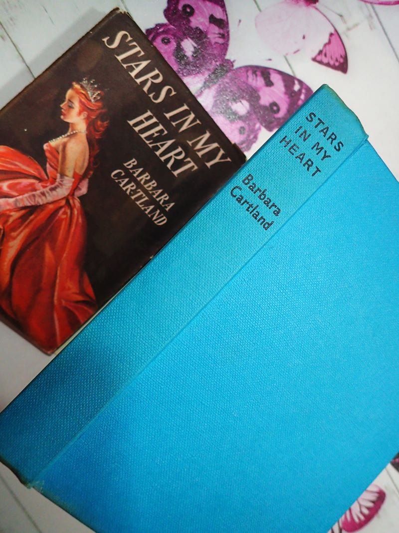 Blue boards and black titles on vintage Barbara Cartland book Stars in My Heart.