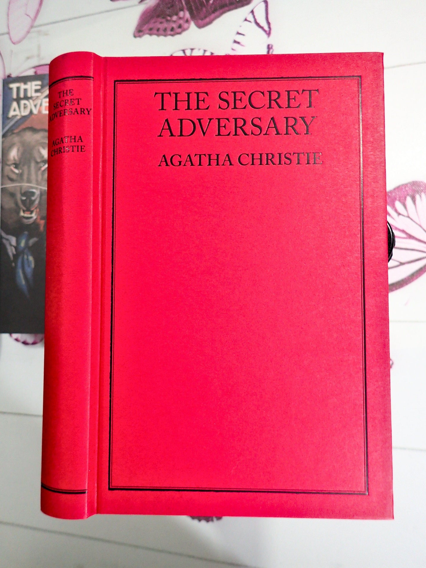 Red binding with black titles of Secret Adversary by Agatha Christie
