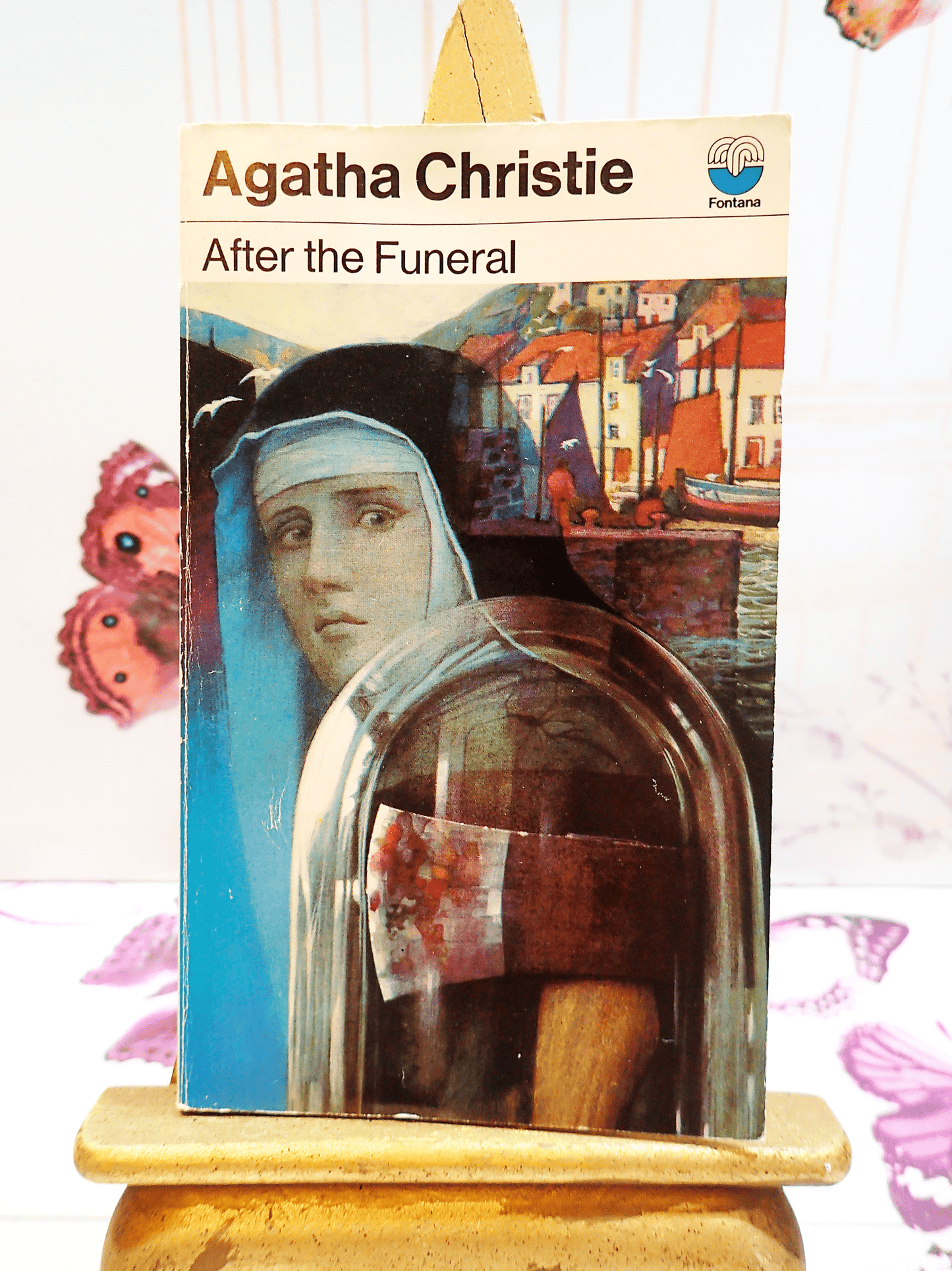 Front cover of After the Funeral by Agatha Christie Vintage Paperback Book Crime Classic 1970's, showing a Nun with an axe against a setting of quaint cottages. 