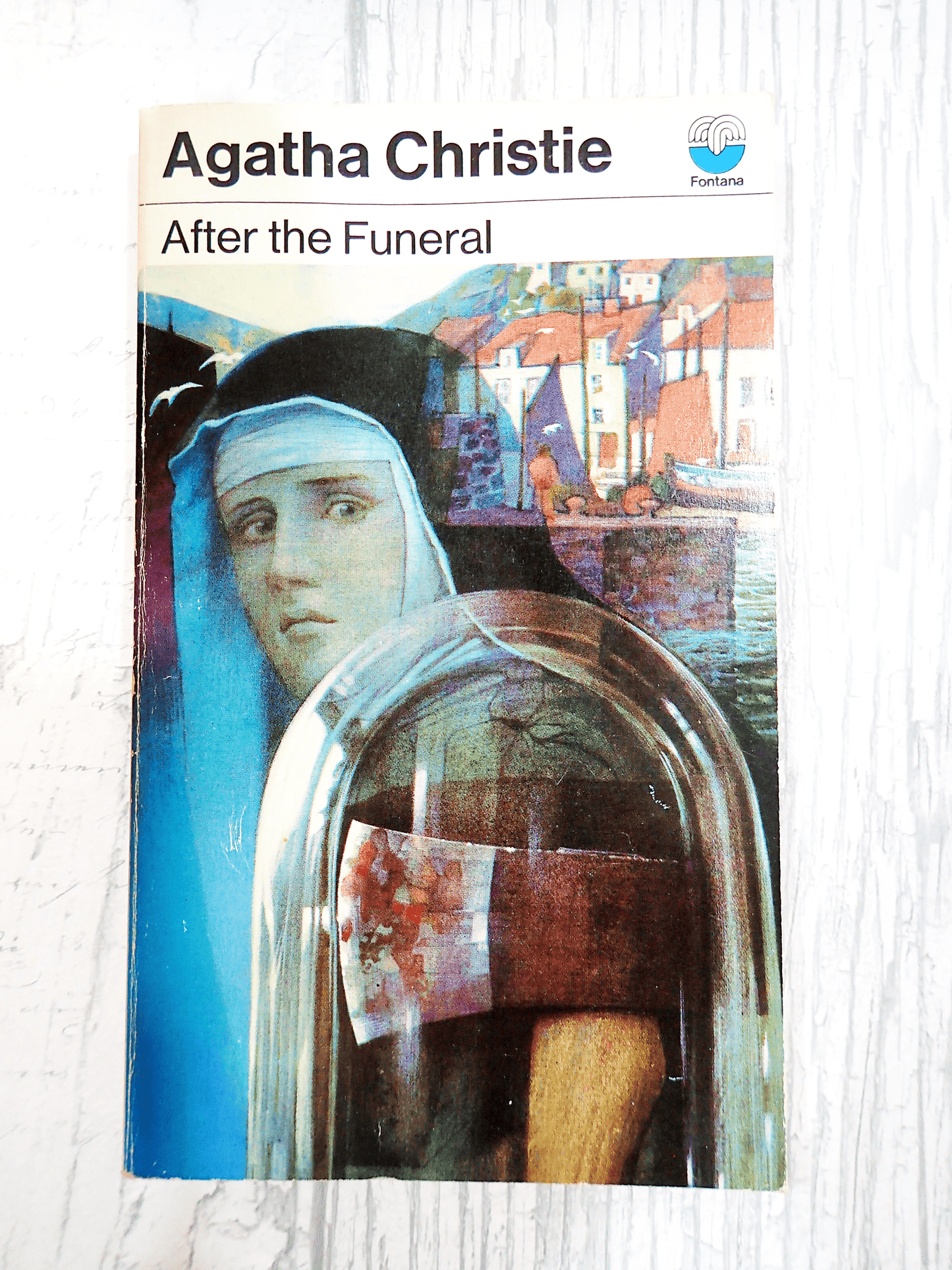 Front cover of After the Funeral by Agatha Christie Vintage Paperback Book Crime Classic 1970's, showing a Nun with an axe against a setting of quaint cottages on a light background. 
