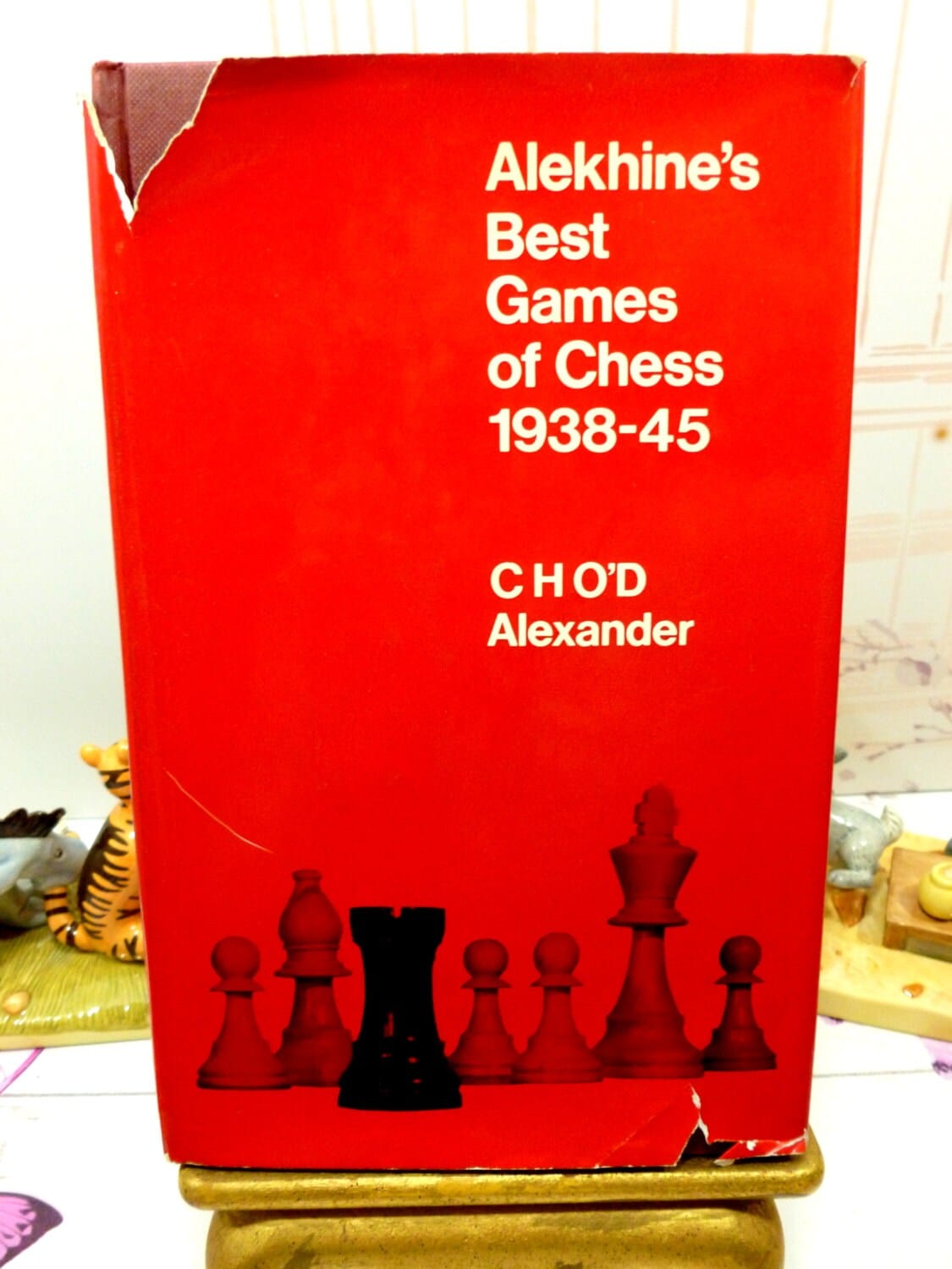 Alekhines Best Games of Chess 1938-45 Hardback book with dust jacket showing tears and images of chesspieces.