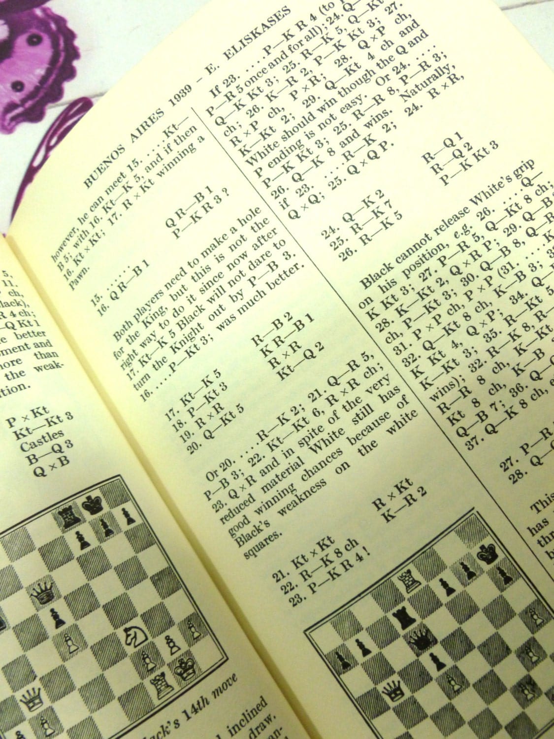 Chess diagrams in black and white on a page from Alekhines Best Games of Chess 1938-45 hardback book. 