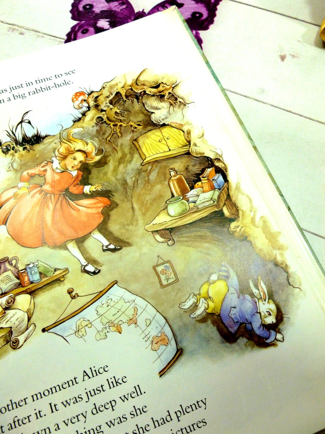 The Mad HatteAlice wearing an orange dress falling down the rabbit hole illustration from vintage Alice in Wonderland book by Rene Cloke. 