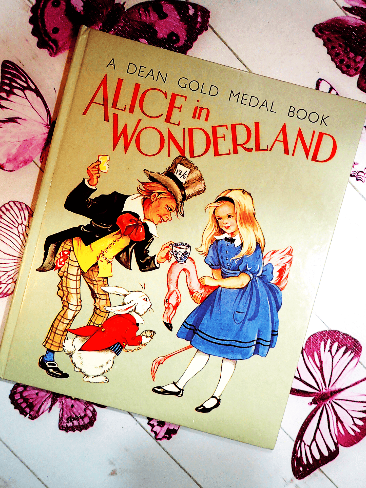 The Mad Hatter, White Rabbit and Alice on the Front cover of Alice in Wonderland Dean Gold Medal Book Hardback