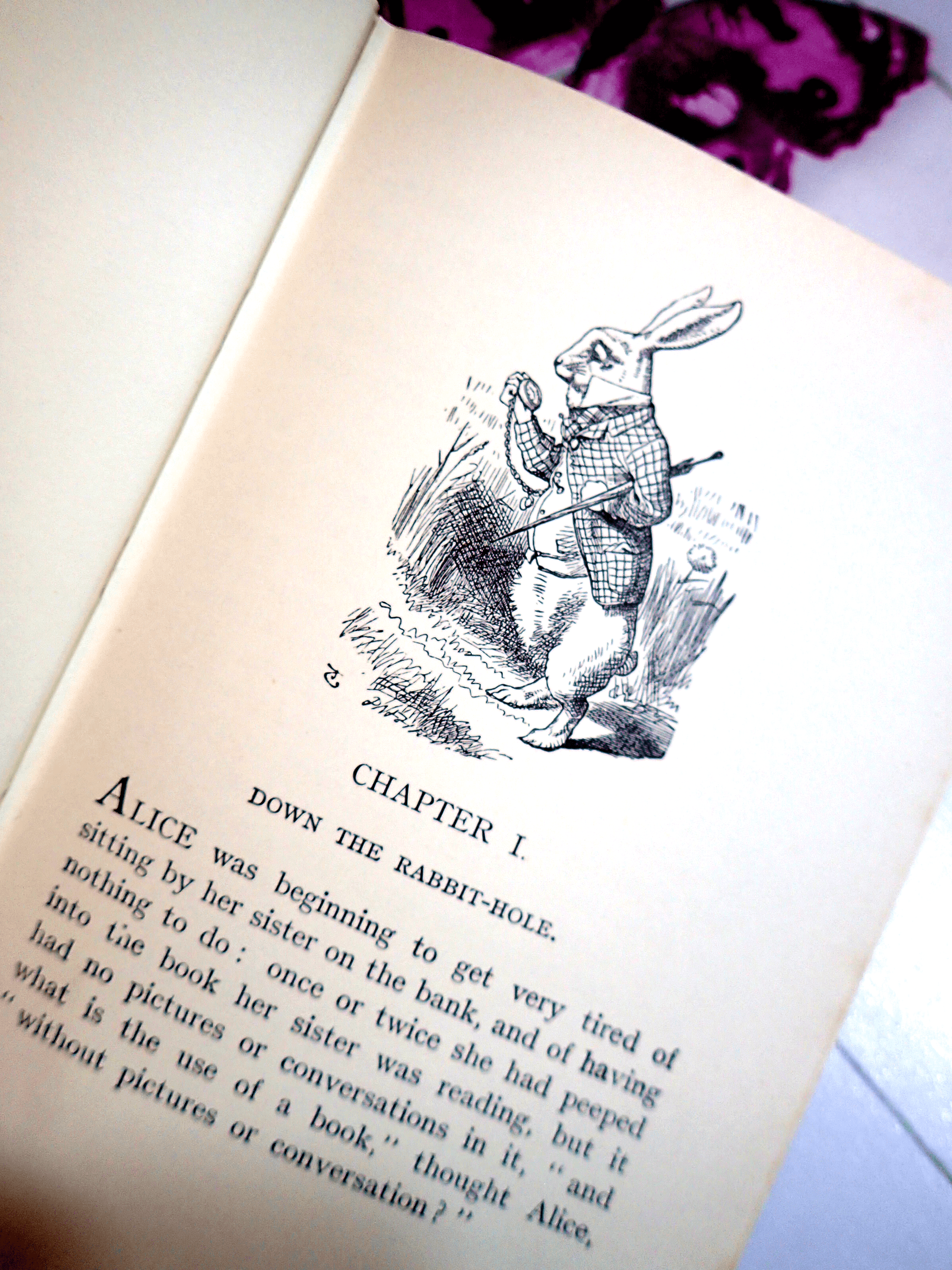 Page of Alice in Wonderland Lewis Carroll Warne Vintage Hardback Book showing the White Rabbit looking at his pocket watch.