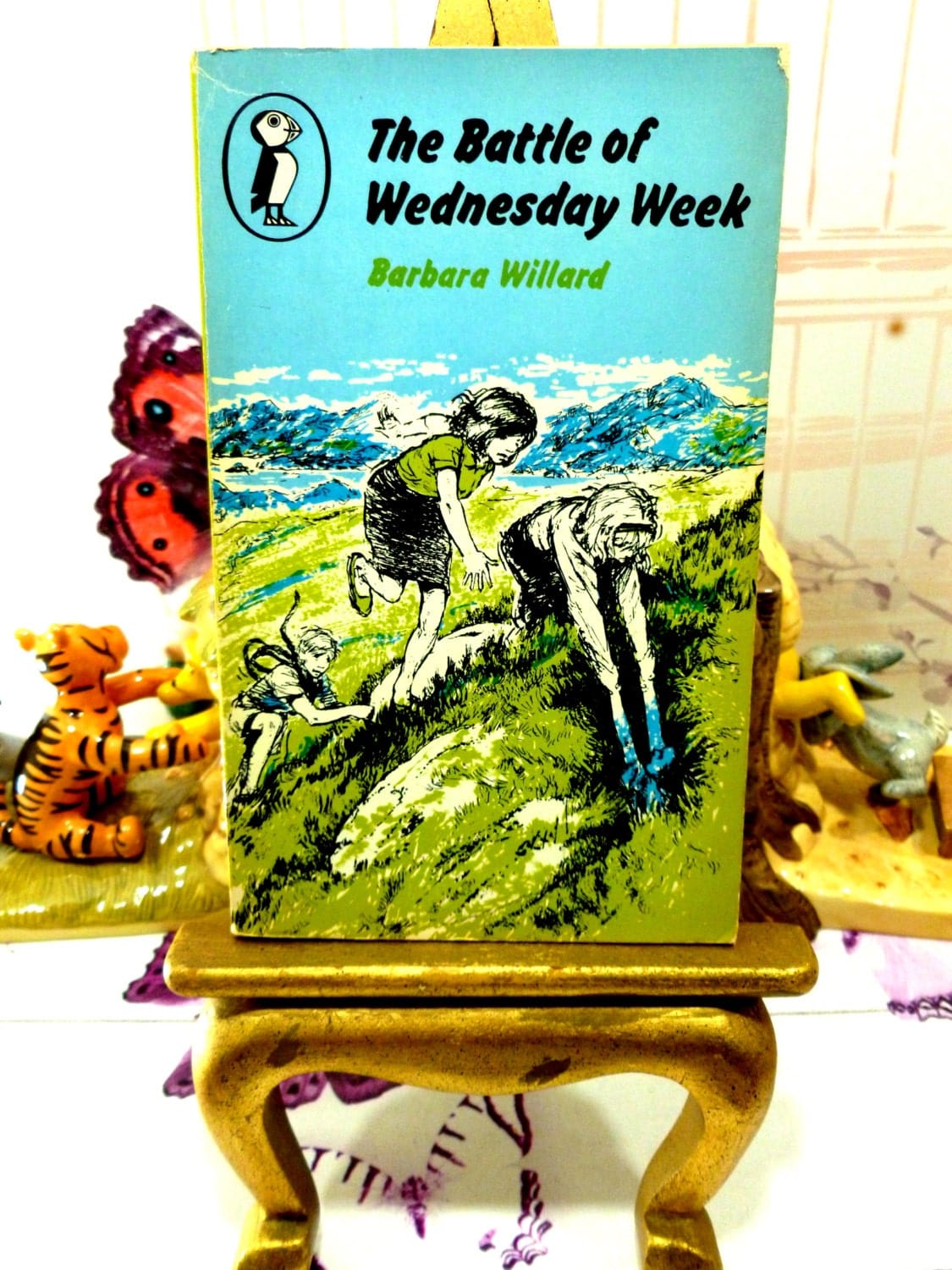 Front cover showing children playing of The Battle of Wednesday Week Sweet Childrens Classic Vintage Puffin Book Paperback 1960s First Edition.