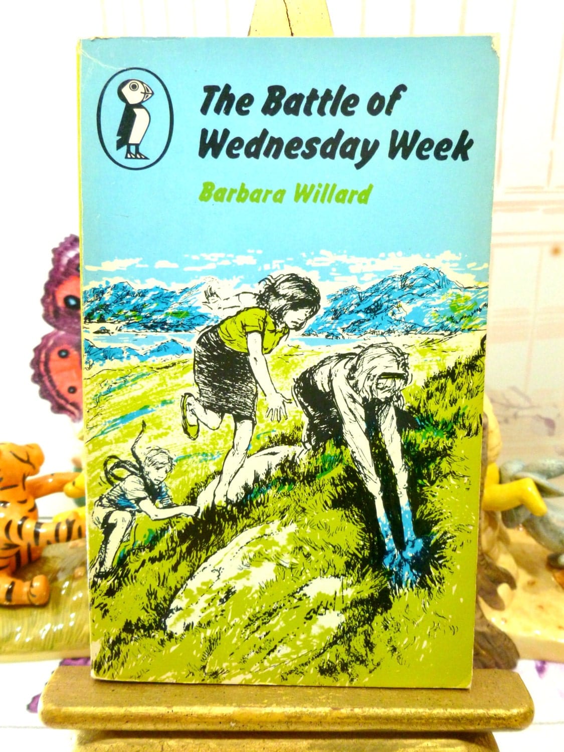 Front cover showing children playing of The Battle of Wednesday Week Sweet Childrens Classic Vintage Puffin Book Paperback 1960s First Edition.