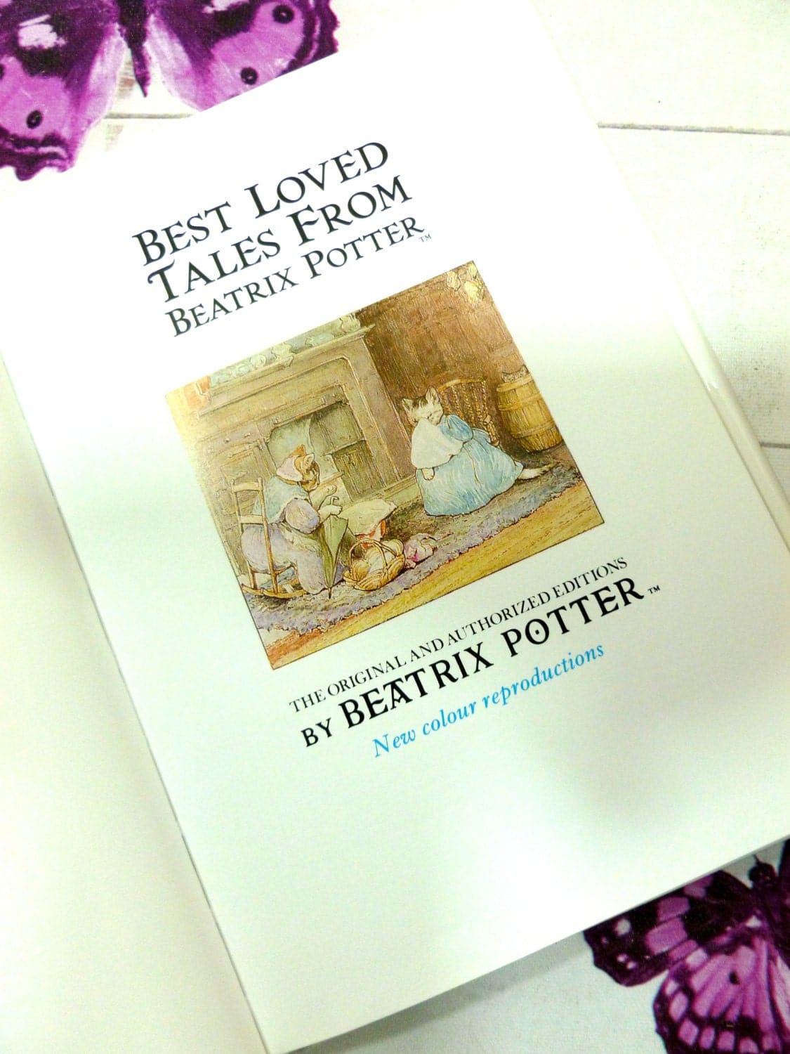 Title page of Beatrix Potter Best Loved Tales showing watercolour illustrations of cute dressed cats by Beatrix Potter. 