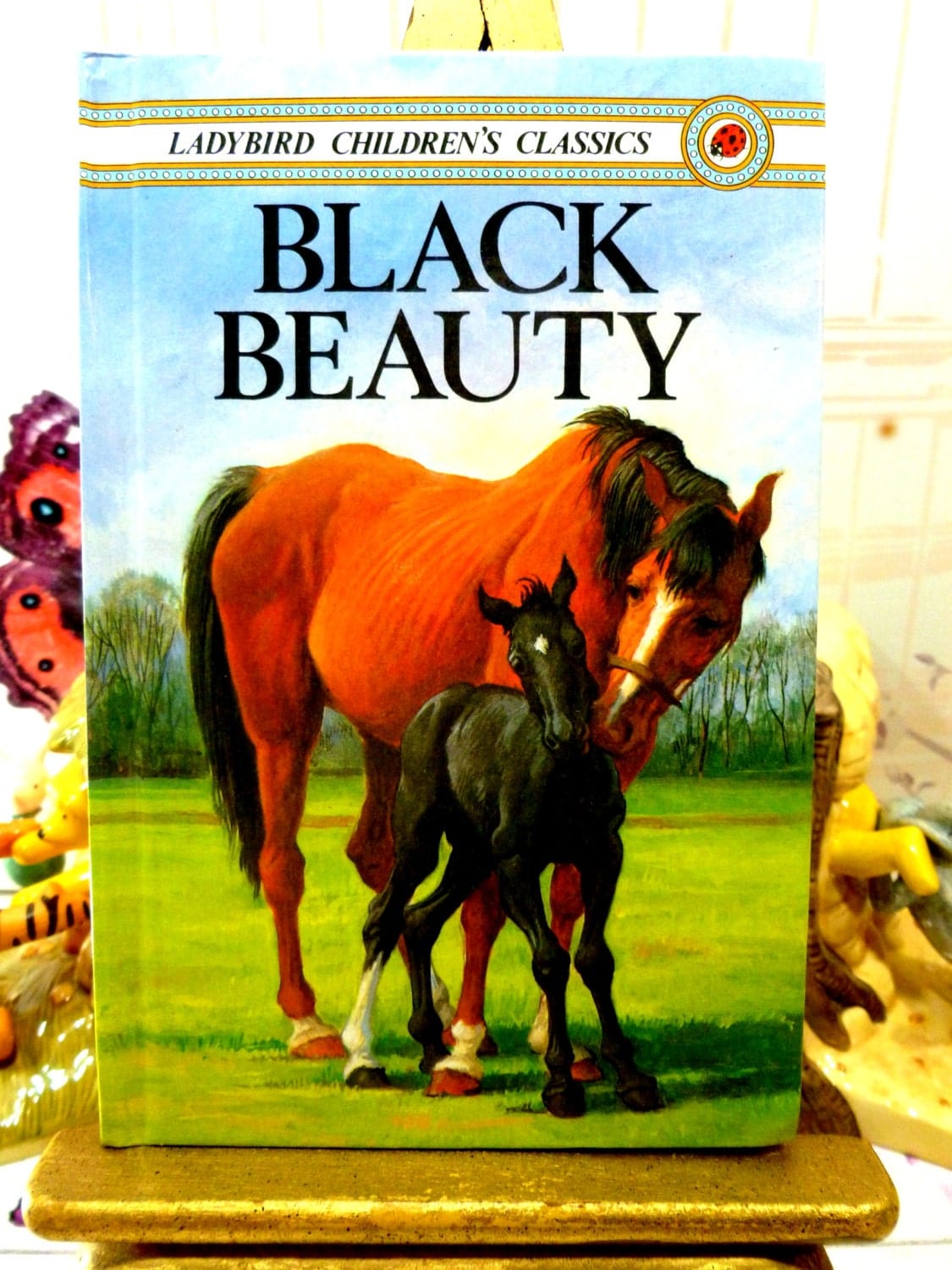 Cover of Black Beauty Vintage Ladybird Book Well Loved Tales showing beautiful Bay horse with black foal. 