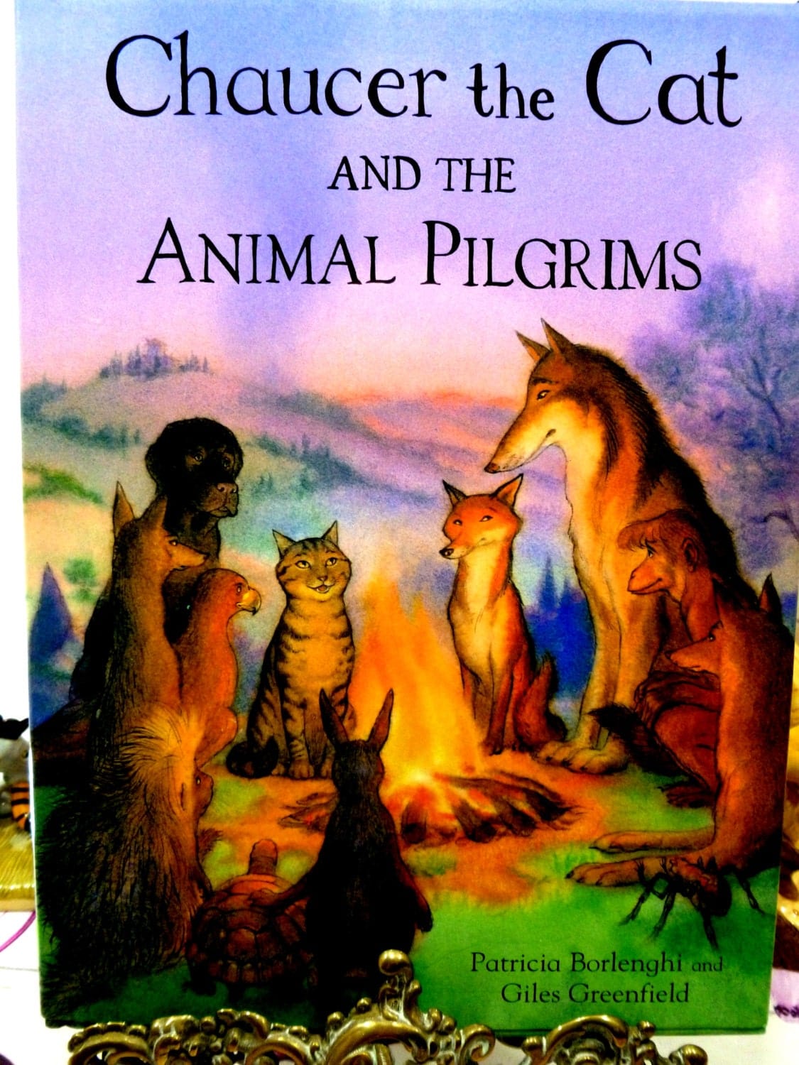 Cover of vintage children's book Chaucer the Cat and the Animal Pilgrims showing animals sat round a campfire. 