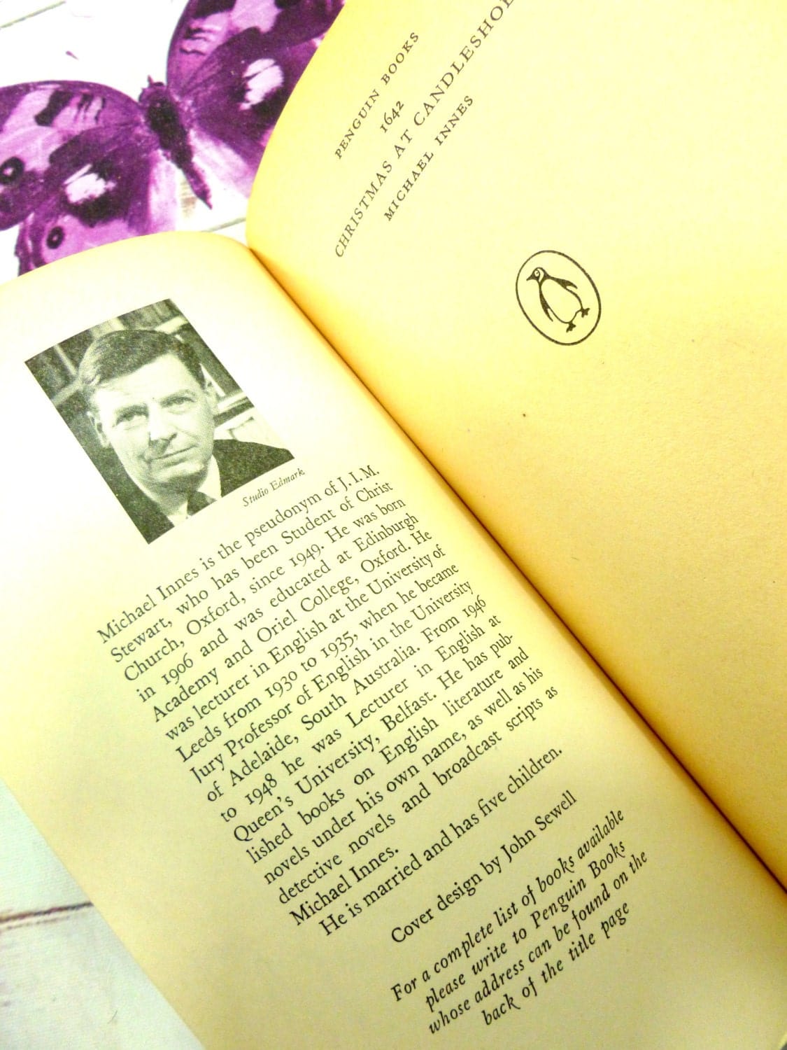 Inner cover of Vintage Penguin Paperback Christmas at Candleshoe by Michael Innes First Edition showing a grayscale photograph of Michael Innes.