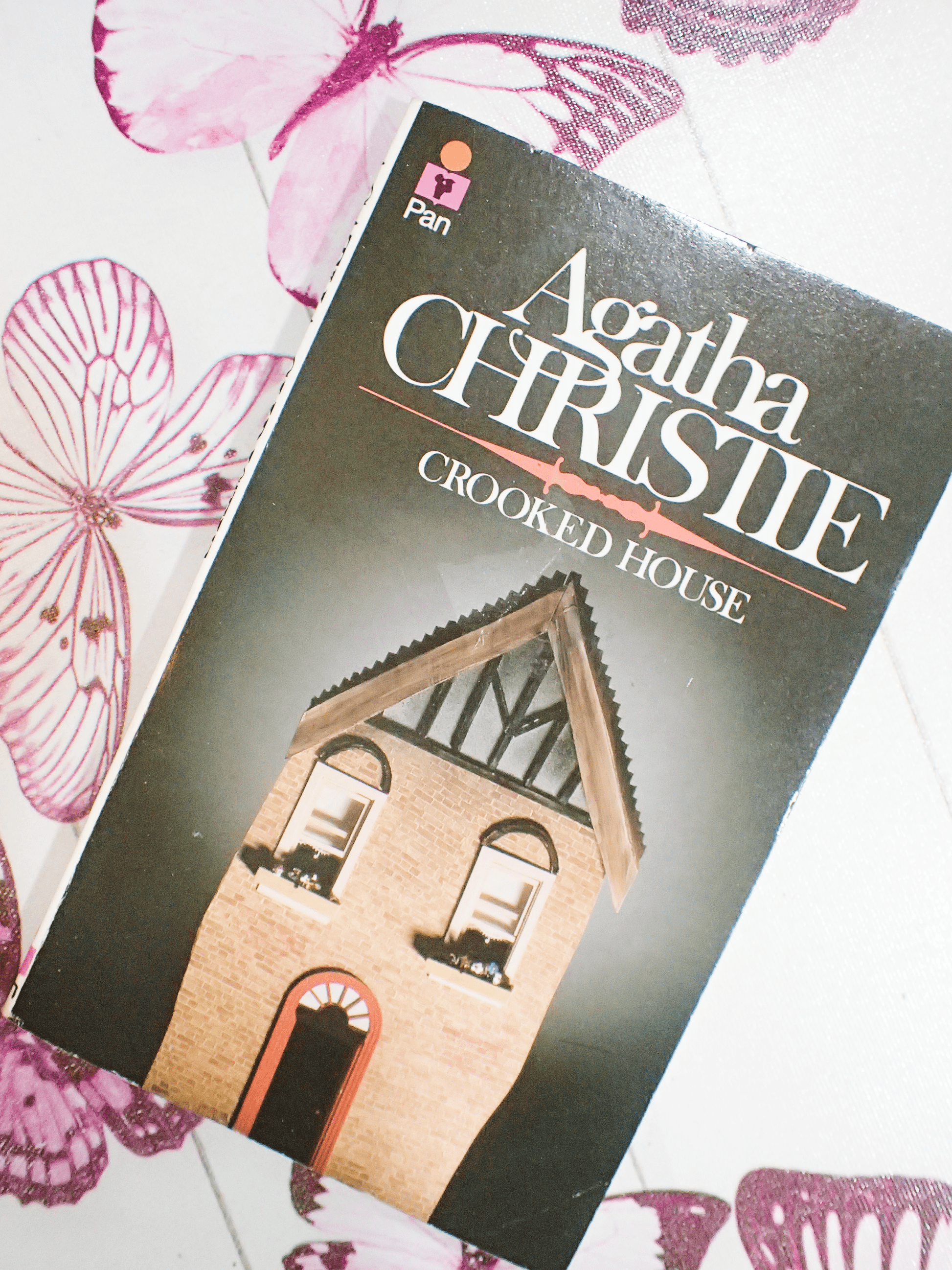 Front cover of Vintage Pan Paperback Agatha Christie 'Crooked House' showing a charming crooked red brick house against a dark cover.