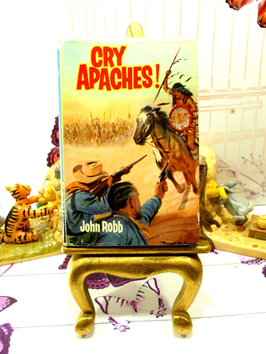 Cover of Cry Apache Catsfoot Cowboy Stories 1960s Vintage Hardback children's book showing cowboy fighting an Indian with guns. 