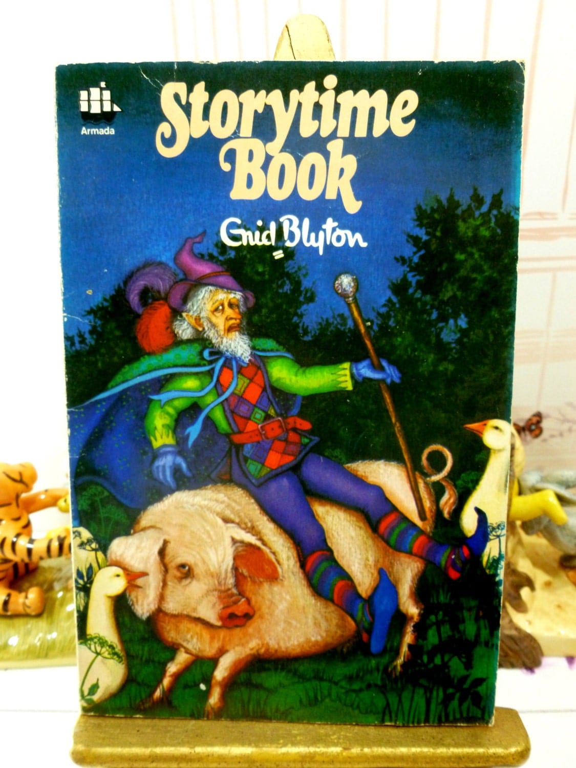 Paperback cover of Enid Blyton Storytime Book Vintage Paperback Armada 1970s showing a fairytale gnome riding a pig. 