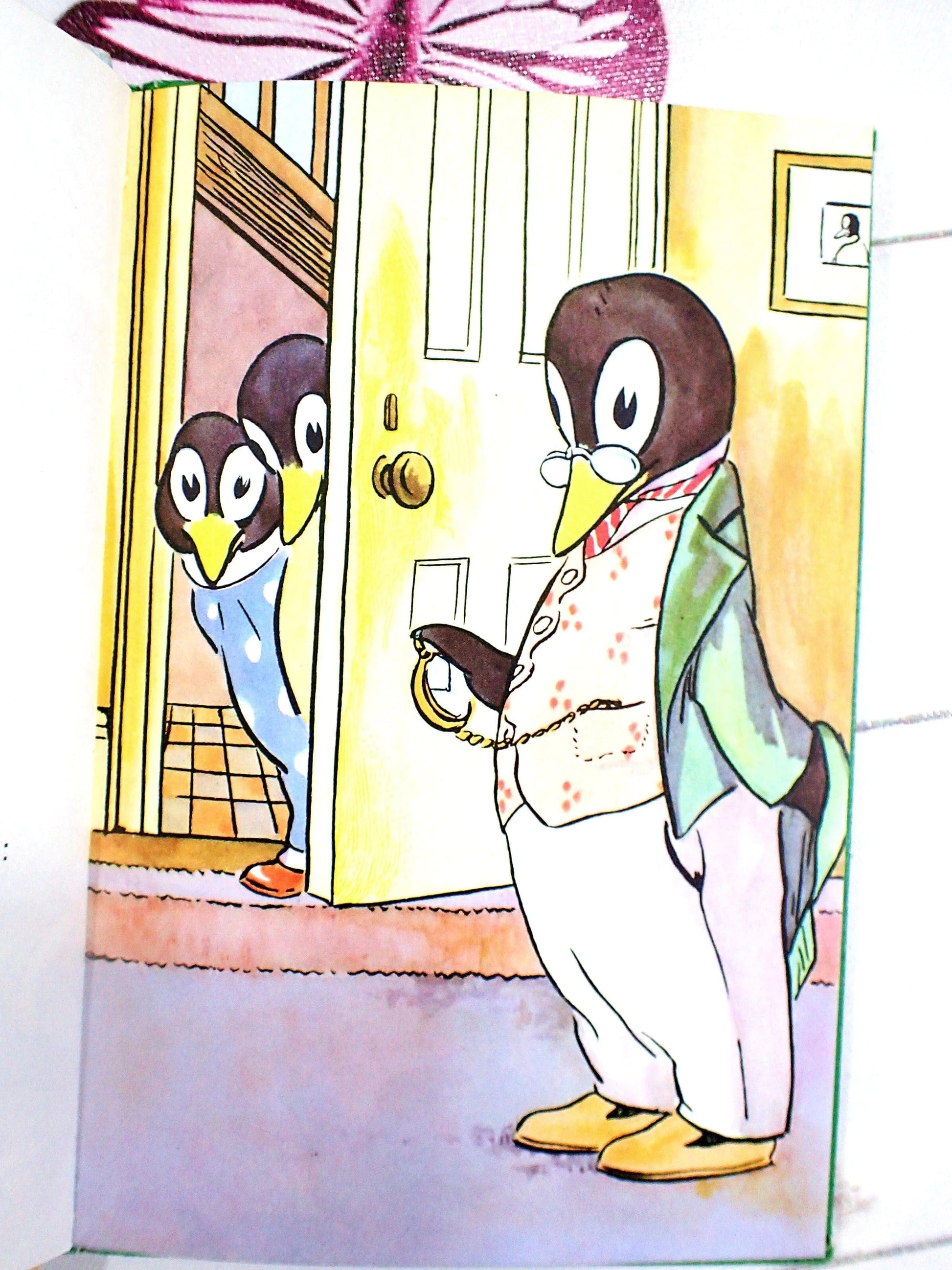 Daddy Penguin in old fashioned clothes looking at a pocket watch.