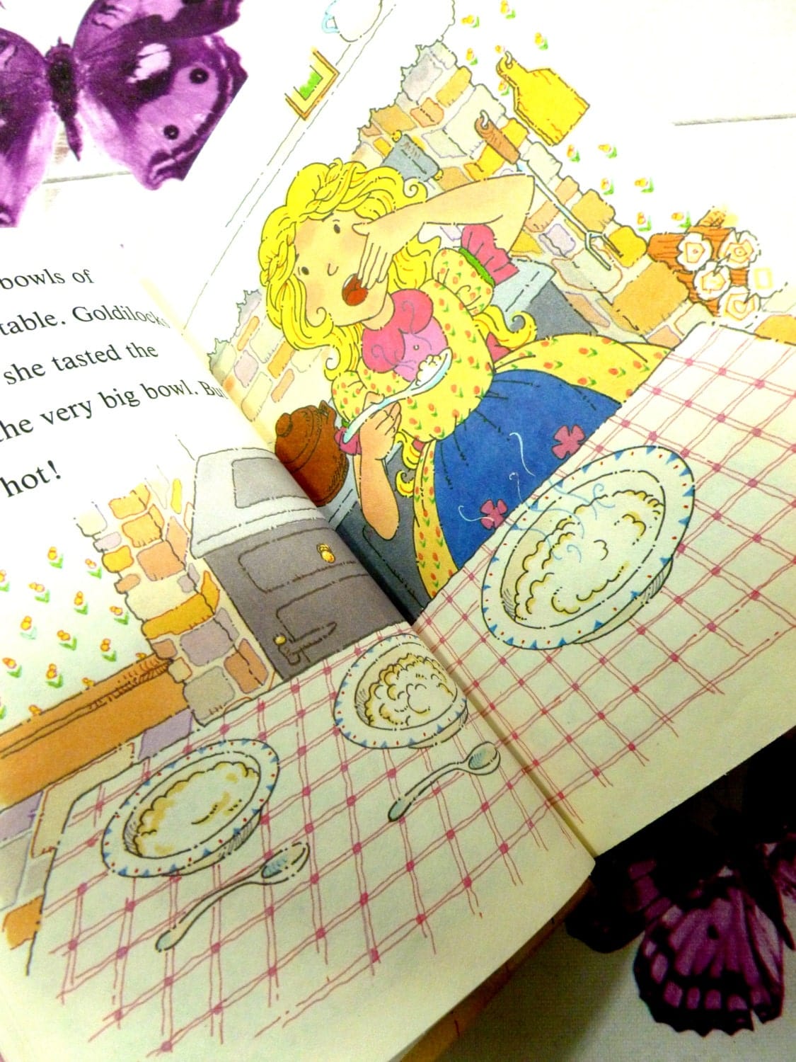 Illustration from vintage Ladybird book showing Goldilocks eating porridge. Goldilocks and the Three Bears. Well Loved Tales.