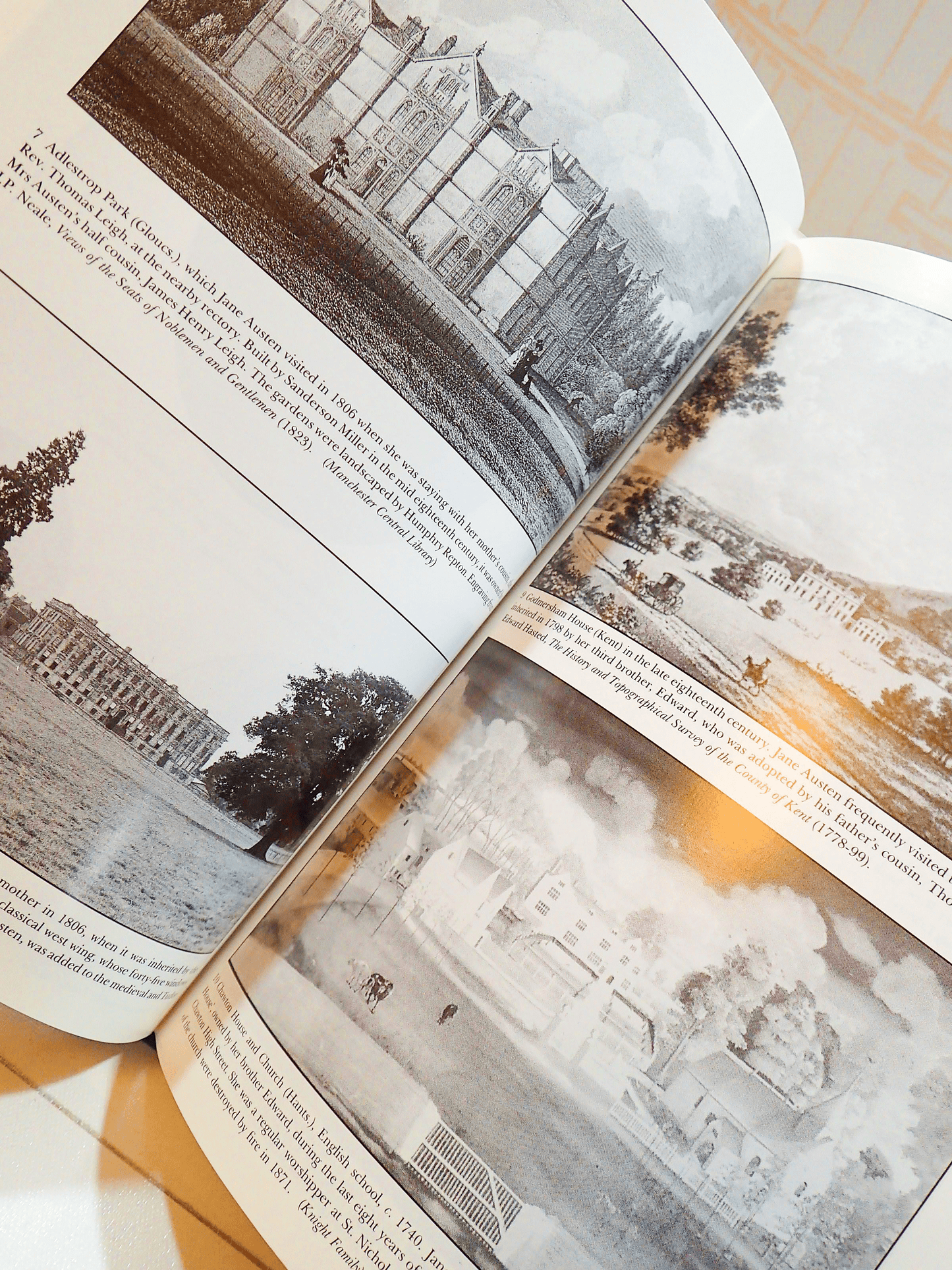 Illustrated pages in vintage book Jane Austen and the Clergy by Irene Collins showing a grayscale engravings of pastoral Regency landscapes and stately piles. 