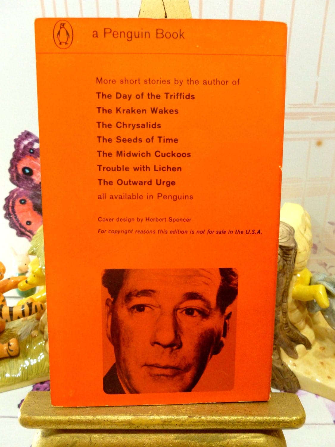 Back cover of Vintage Penguin Orange Paperback John Wyndham First Ed Book Consider Her Ways and Others showing a photo of John Wyndham on an Orange background with list of his other novels. 