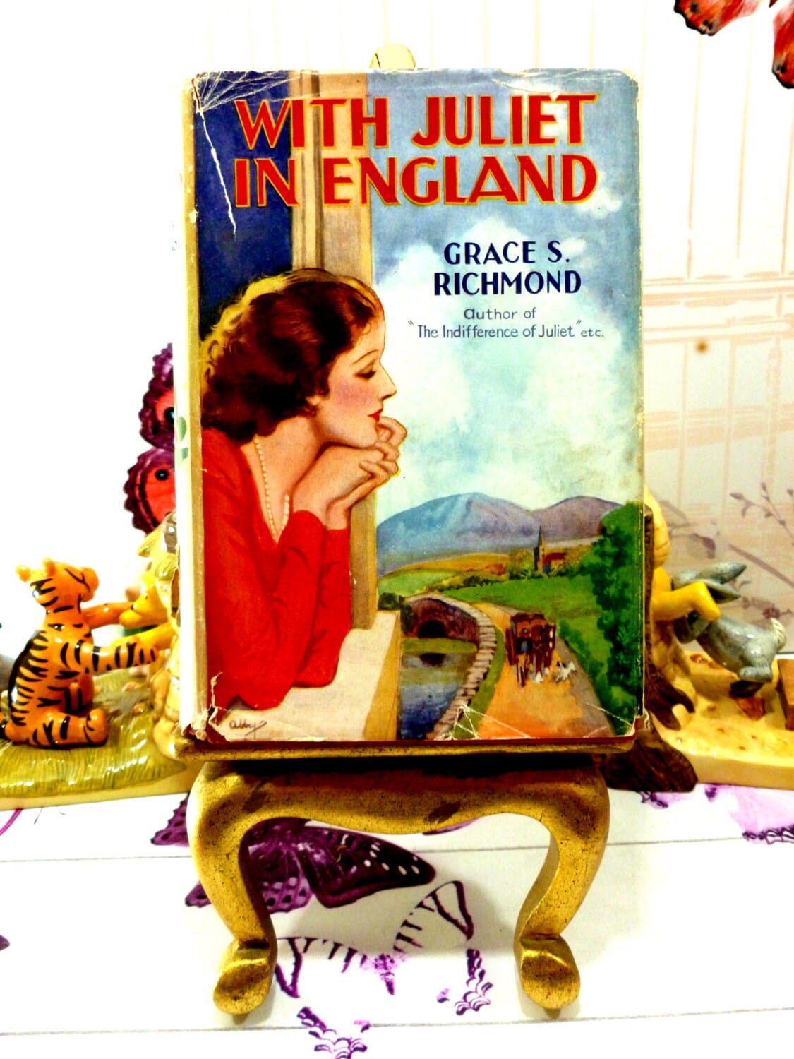 Front cover of With Juliet in England by Grace S Richmond Scarce Vintage 1930s Romance Novel showing a pensive woman looking out of a window.