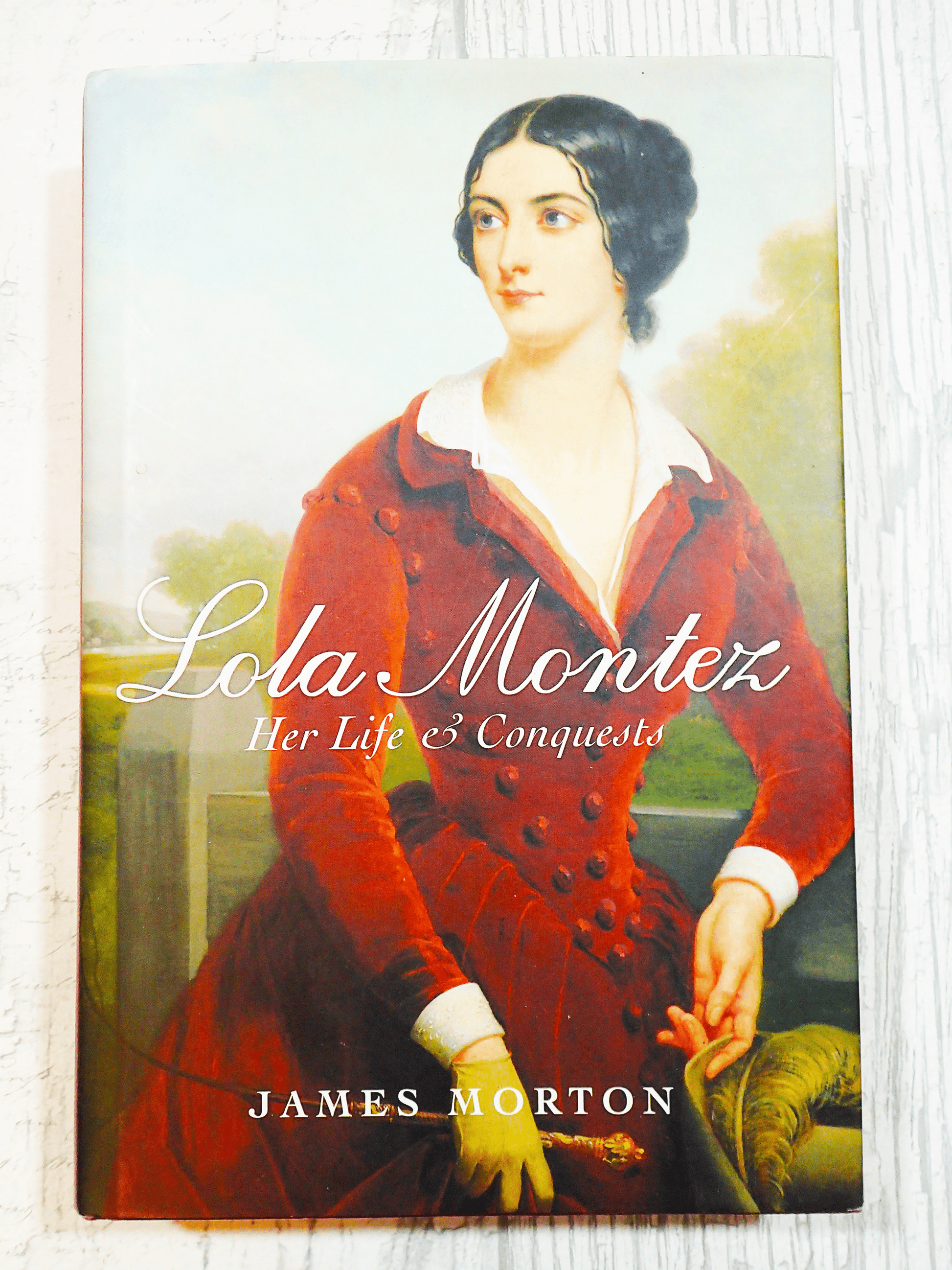 Front cover of Lola Montez Her Life & Conquests by James Morton showing beautiful portrait of Lola Montez in a red velvet gown against a light background.