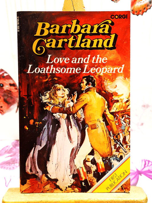 Front cover of Love and the Loathsome Leopard Barbara Cartland Corgi paperback showing a frightened woman in a cape being rescued by a handsome man.