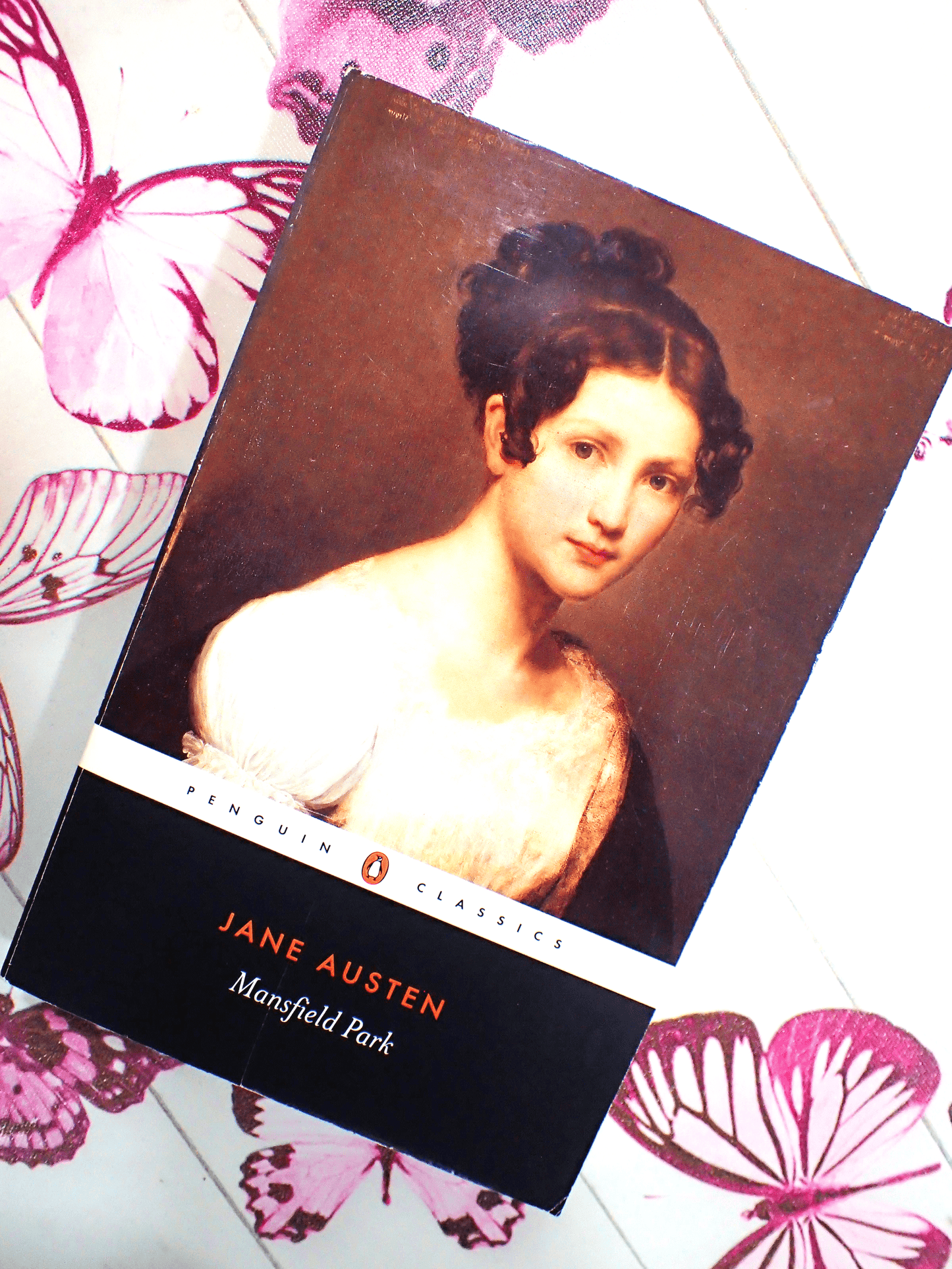 Front cover of Mansfield Park Jane Austen Penguin Classics showing a portrait of a Regency Girl with butterflies in the background. 