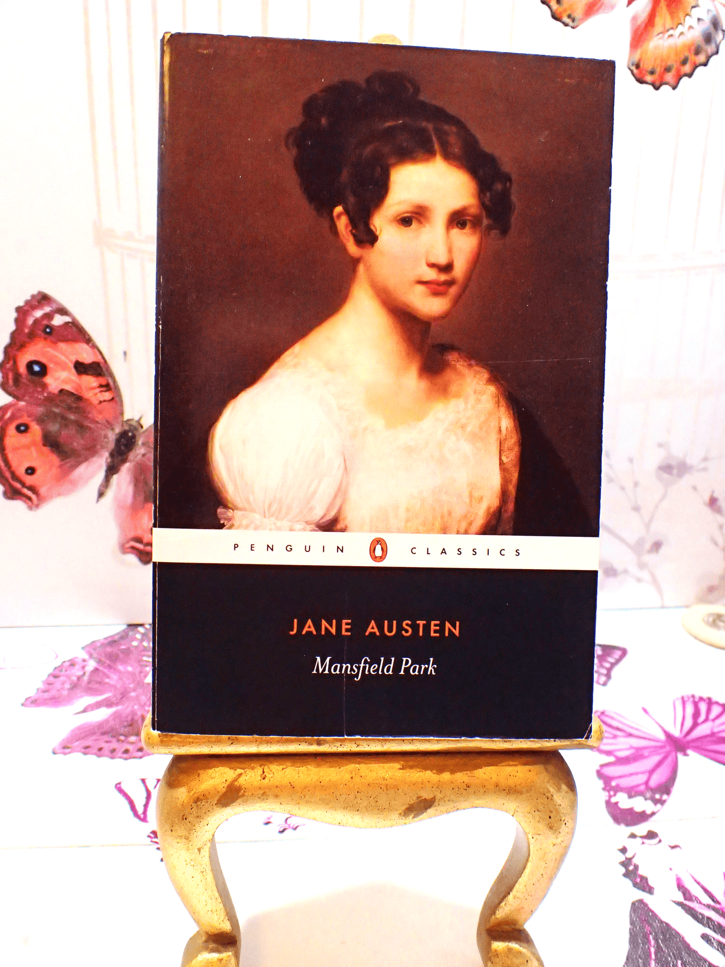 Front cover of Mansfield Park Jane Austen Penguin Classics showing a portrait of a Regency Girl against a butterfly background. 
