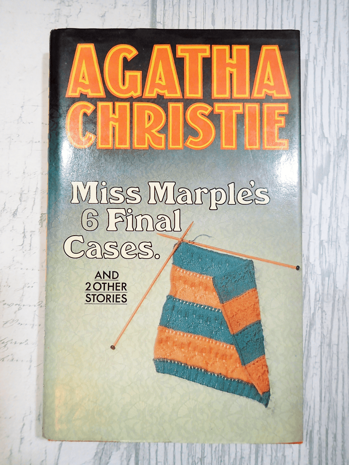 Front cover of Agatha Christie Miss Marples Final Cases Collins Crime Club First Edition Book 1979 showing some stripey knitting and titles in orange against a light background.