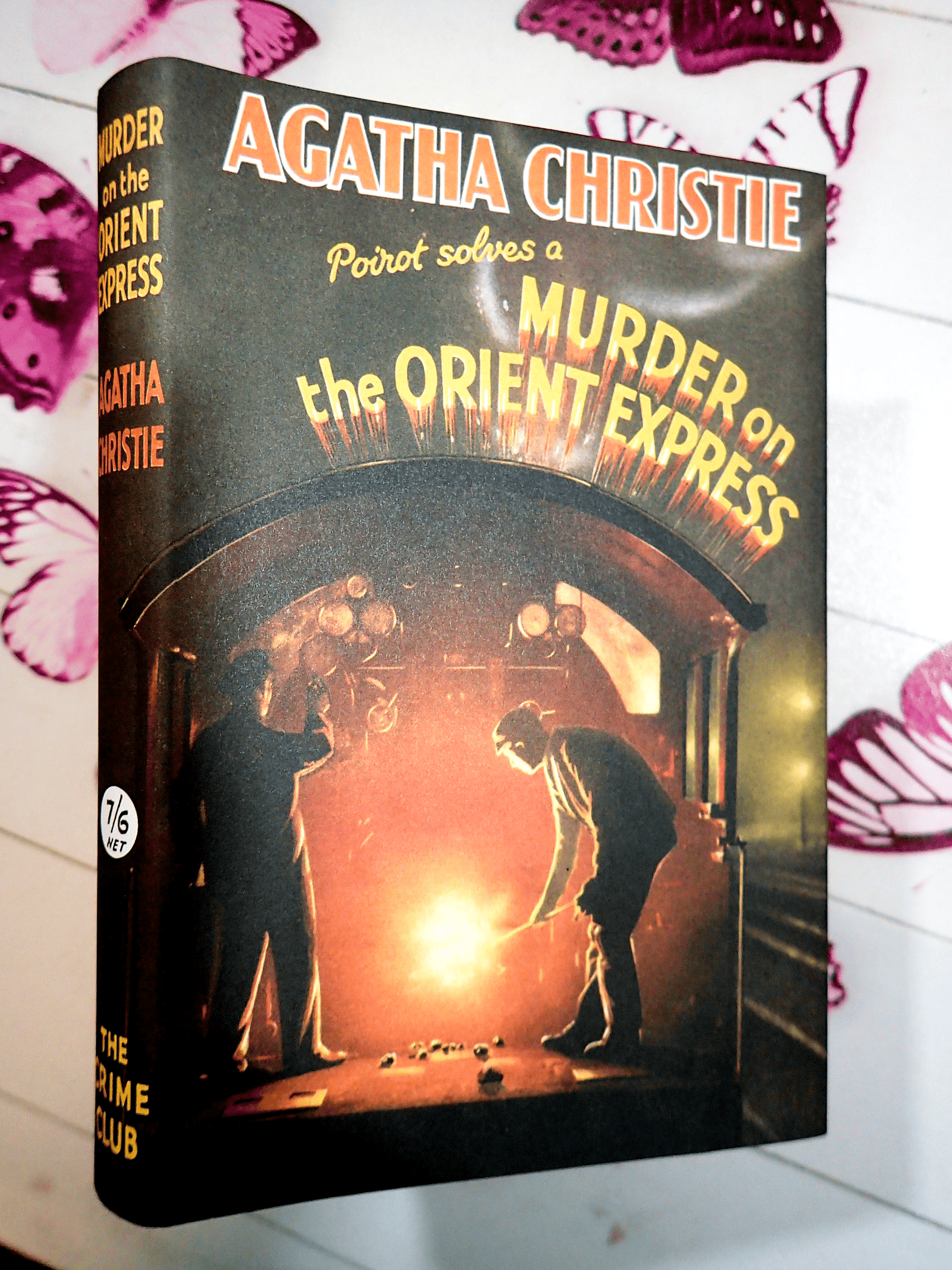 Front cover of Murder on the Orient Express Agatha Christie Facsimile Vintage Book showing a man shovelling coal into a train furnace. 