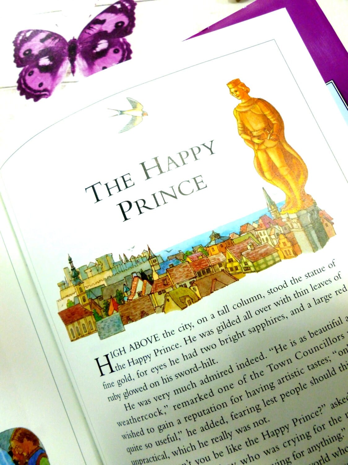 Page from Front cover of Oscar Wilde Fairy Stories for Children inc the Happy Prince Vintage Fairy tale Book showing a picture of the Happy Prince golden statue and the swallow. 