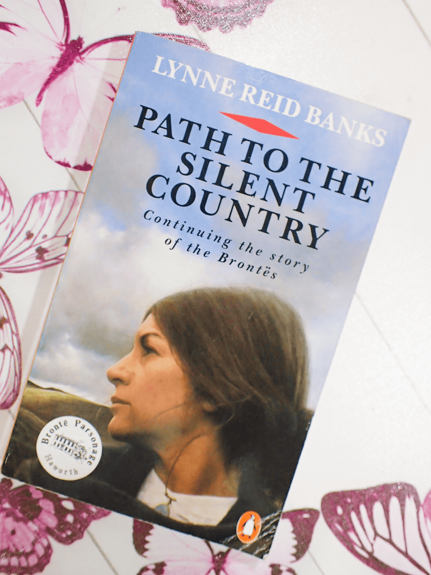 Front cover of vintage Bronte interest book  'Path to the Silent Country' by Lynne Reid Banks - showing a wistful woman gazing over the moors. 