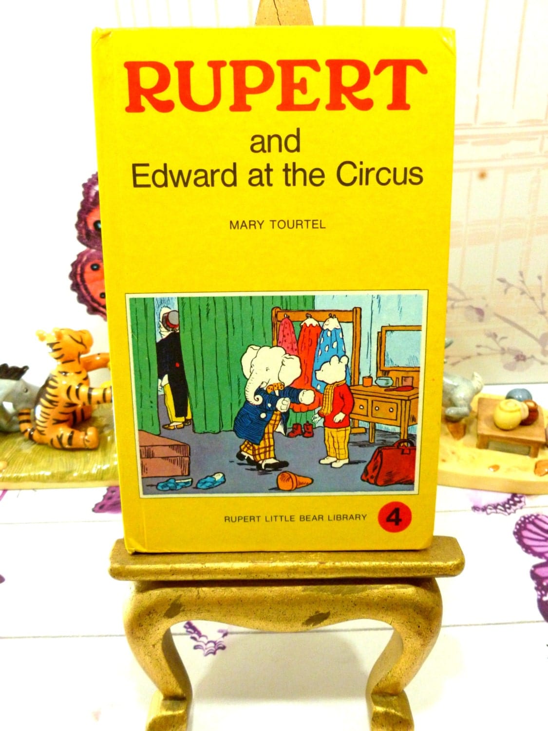 Front cover of yellow vintage book Rupert and Edward at the Circus Mary Tourtel Little Bear Library number 4 1970s first edition showing Rupert and Edward the Elephant. 