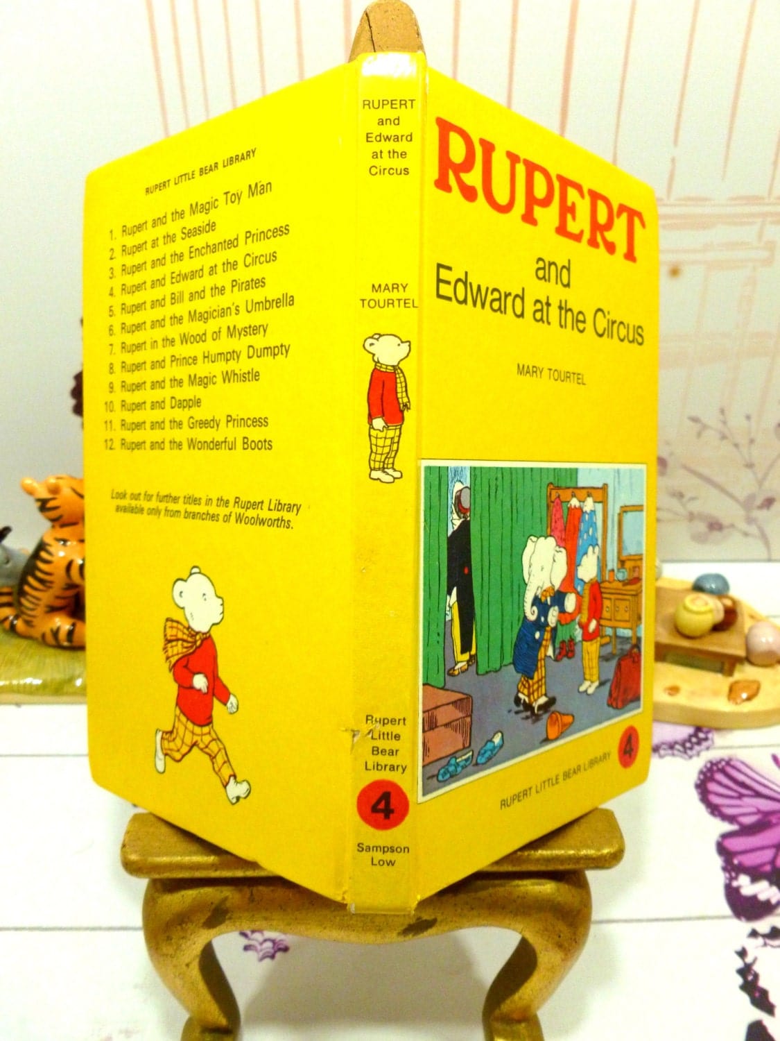 Cover and spine of yellow vintage book Rupert and Edward at the Circus Mary Tourtel Little Bear Library number 4 1970s first edition showing Rupert and Edward the Elephant and Rupert Bear on the spine. 