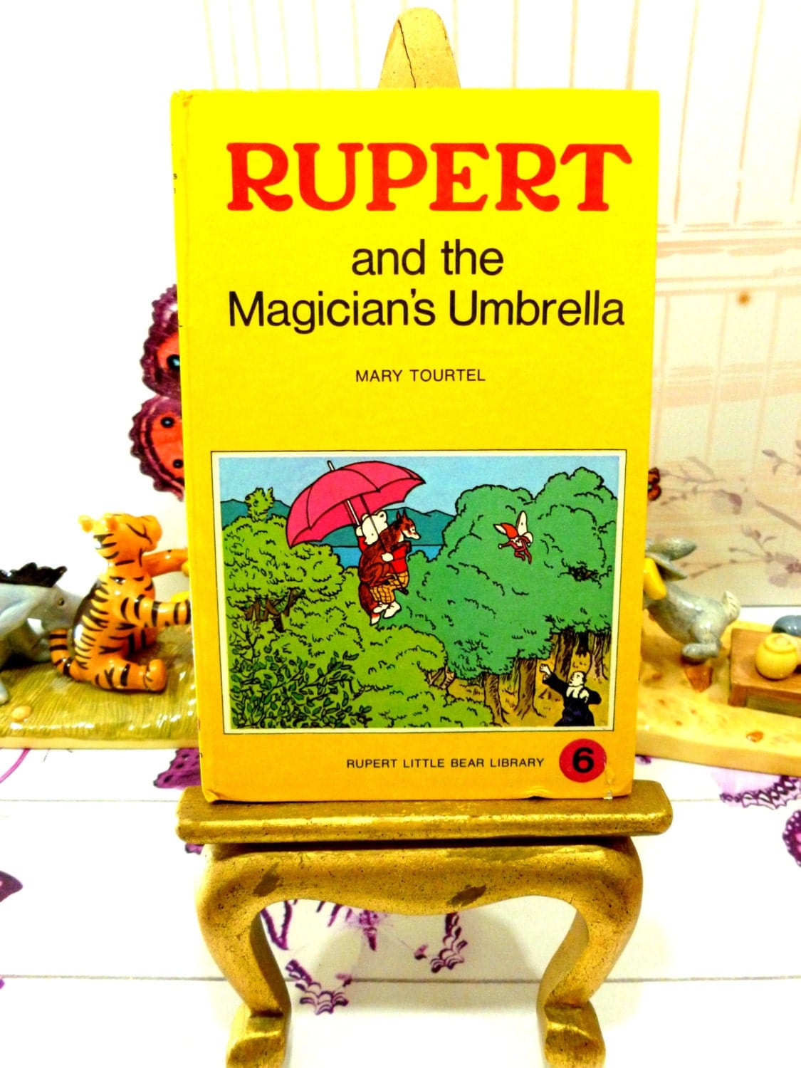 Front cover of yellow book showing Rupert and the Magicians Umbrella Mary Tourtel Little Bear Library number 6 1970s Vintage Hardback Rupert Book 1st Ed.