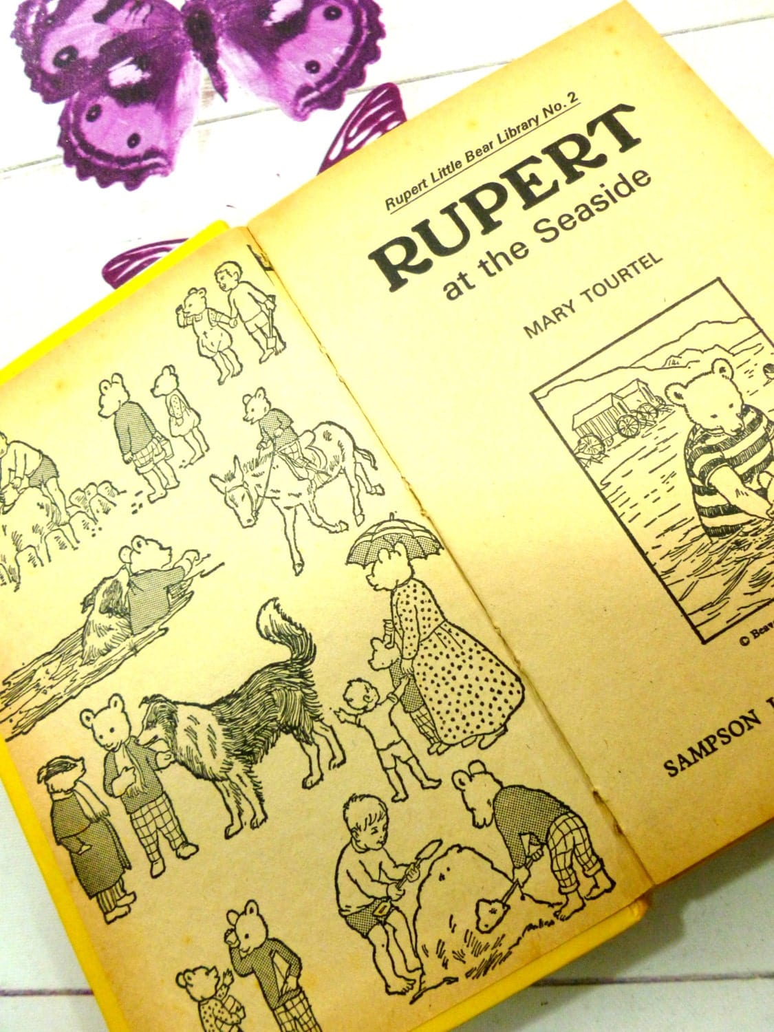 Title page and illustrated endpapers of vintage Rupert bear book showing line drawings of Rupert the Bear characters.