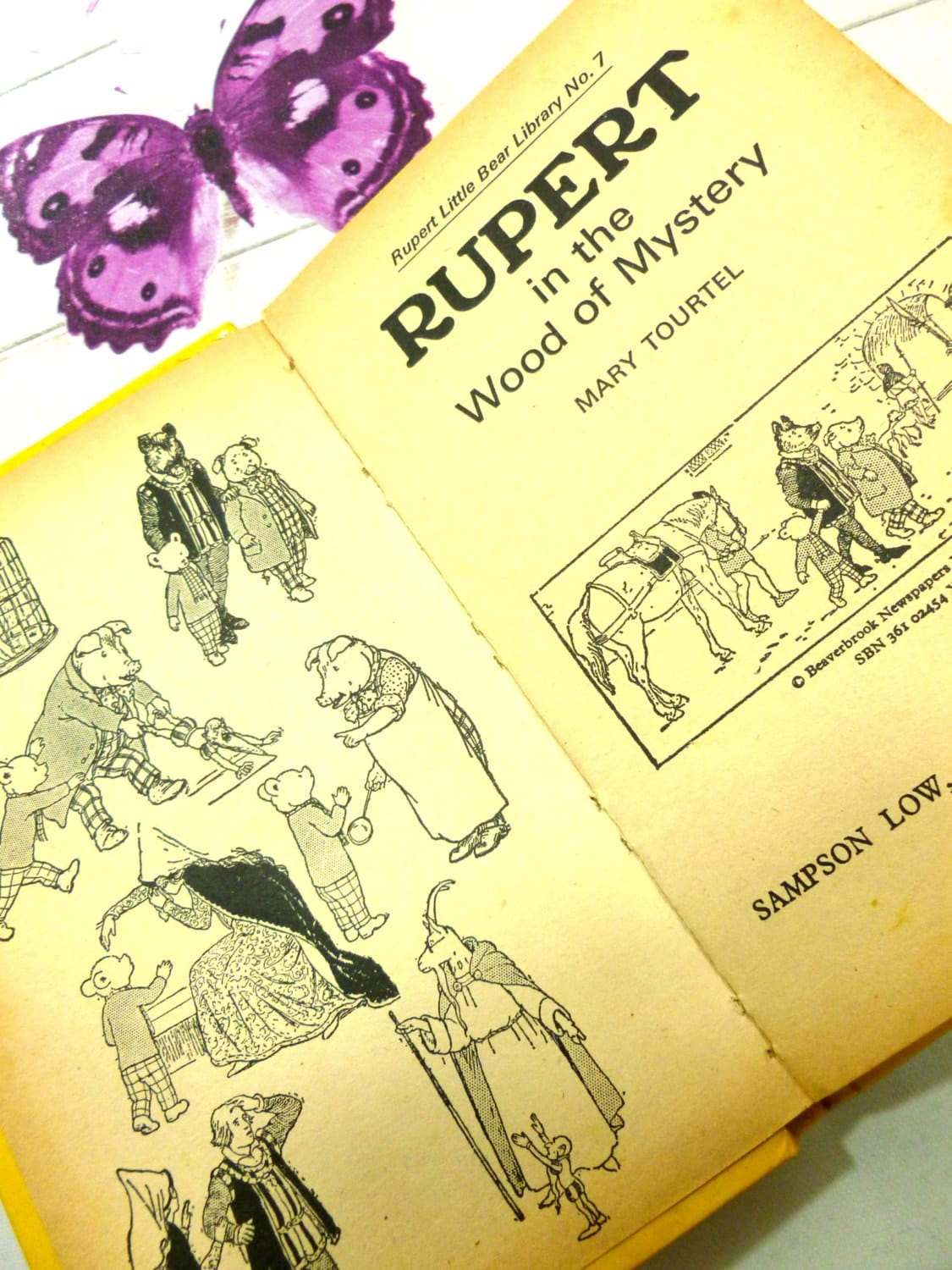 Pages of yellow book showing black and white illustrations of Rupert in the Wood of Mystery and other Rupert the Bear characters Mary Tourtel Little Bear Library number 7 1970s Vintage Hardback Rupert Book 1st Ed