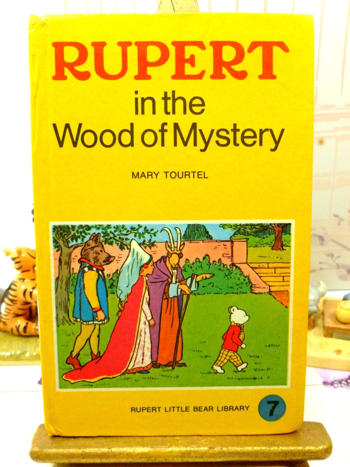 Front cover of yellow book showing Rupert in the Wood of Mystery Mary Tourtel Little Bear Library number 7 1970s Vintage Hardback Rupert Book 1st Ed