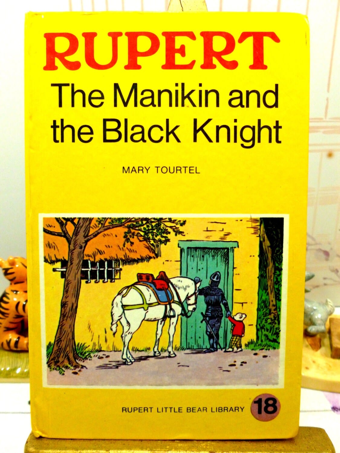 Yellow book showing picture of Rupert The Manikin and the Black Knight Mary Tourtel Little Bear Library number 18 1970s Vintage Hardback Rupert Book 1st Ed