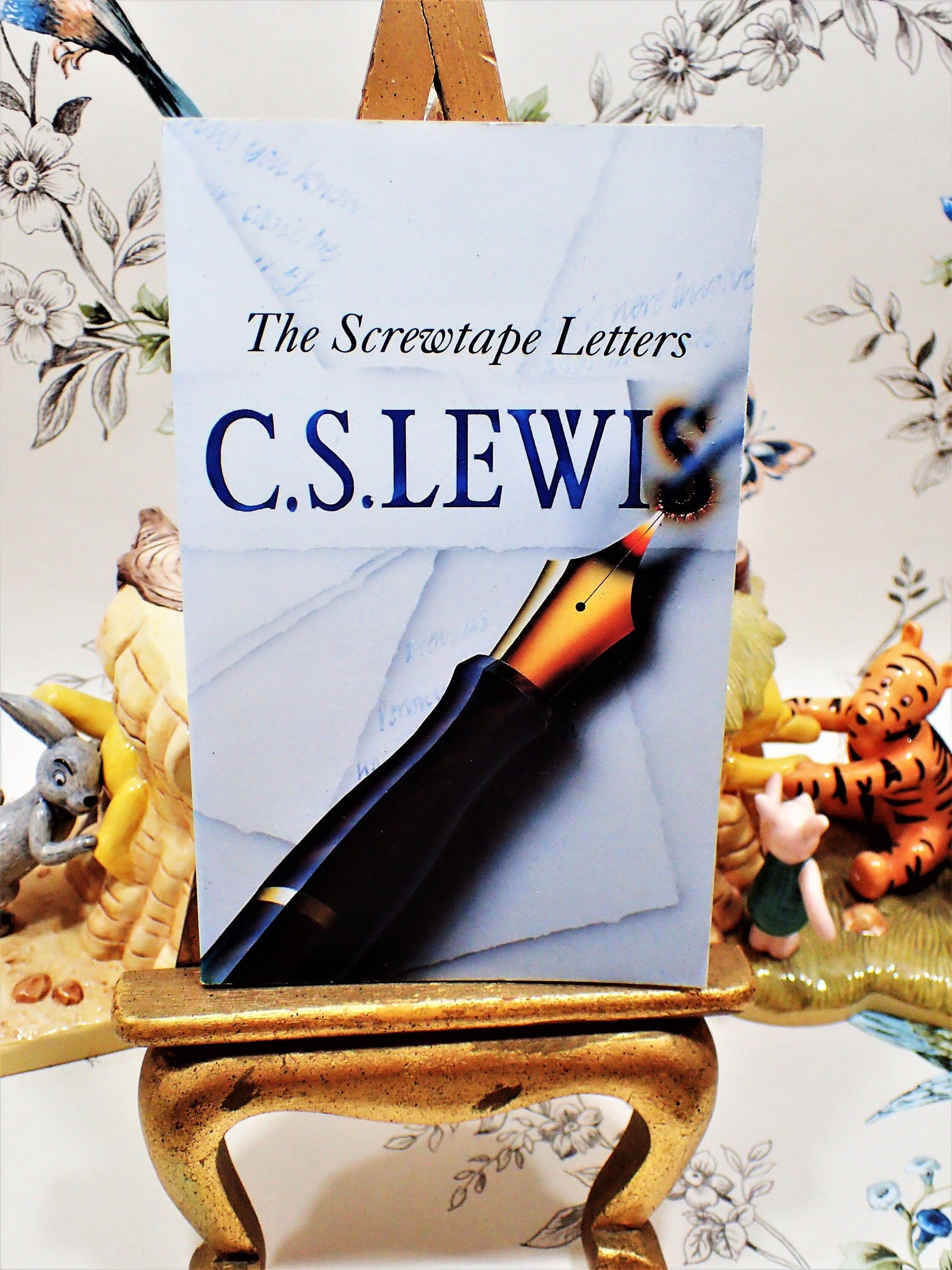 Front cover of The Screwtape Letters C S Lewis Vintage Paperback Book 1970's showing a pen with ink burning through paper on a gray ground. 